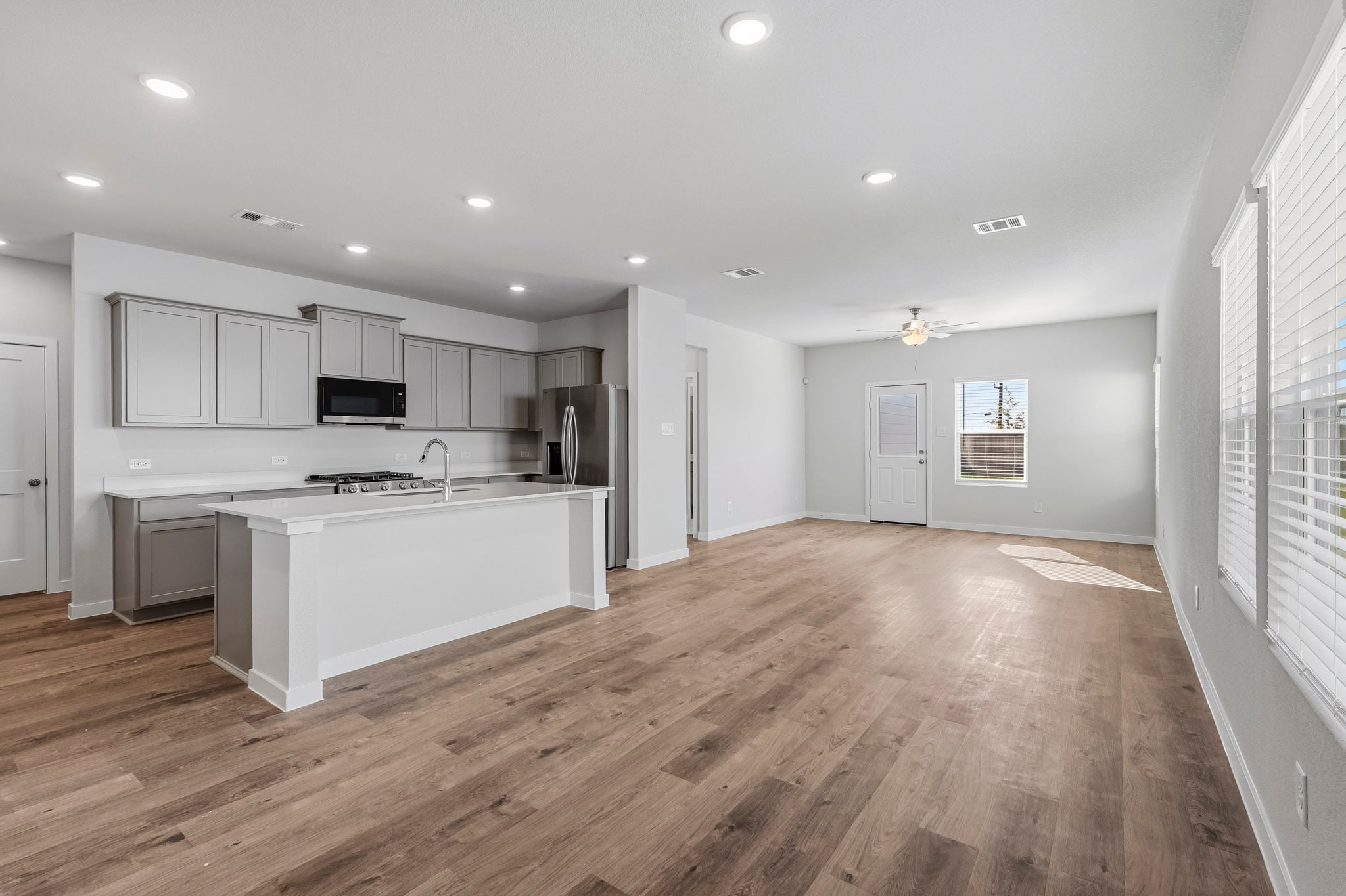 A kitchen with white cabinets.
