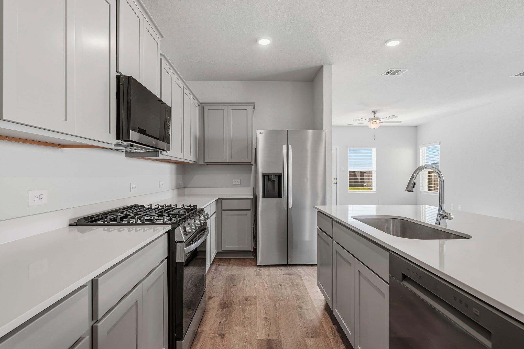 A kitchen with white cabinets.
