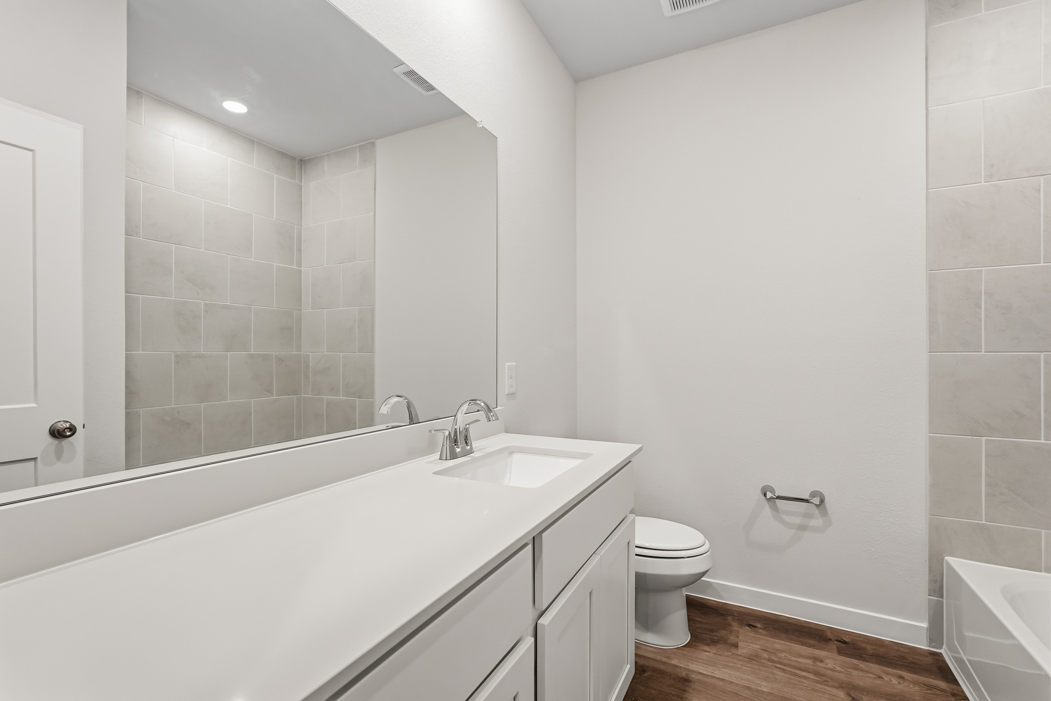 A bathroom with a tub sink and toilet.