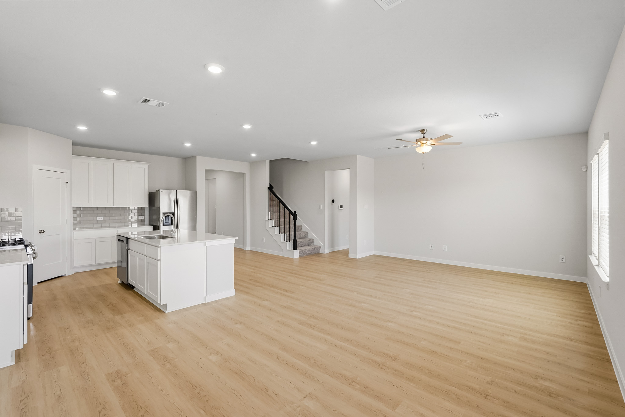A large kitchen with white cabinets.