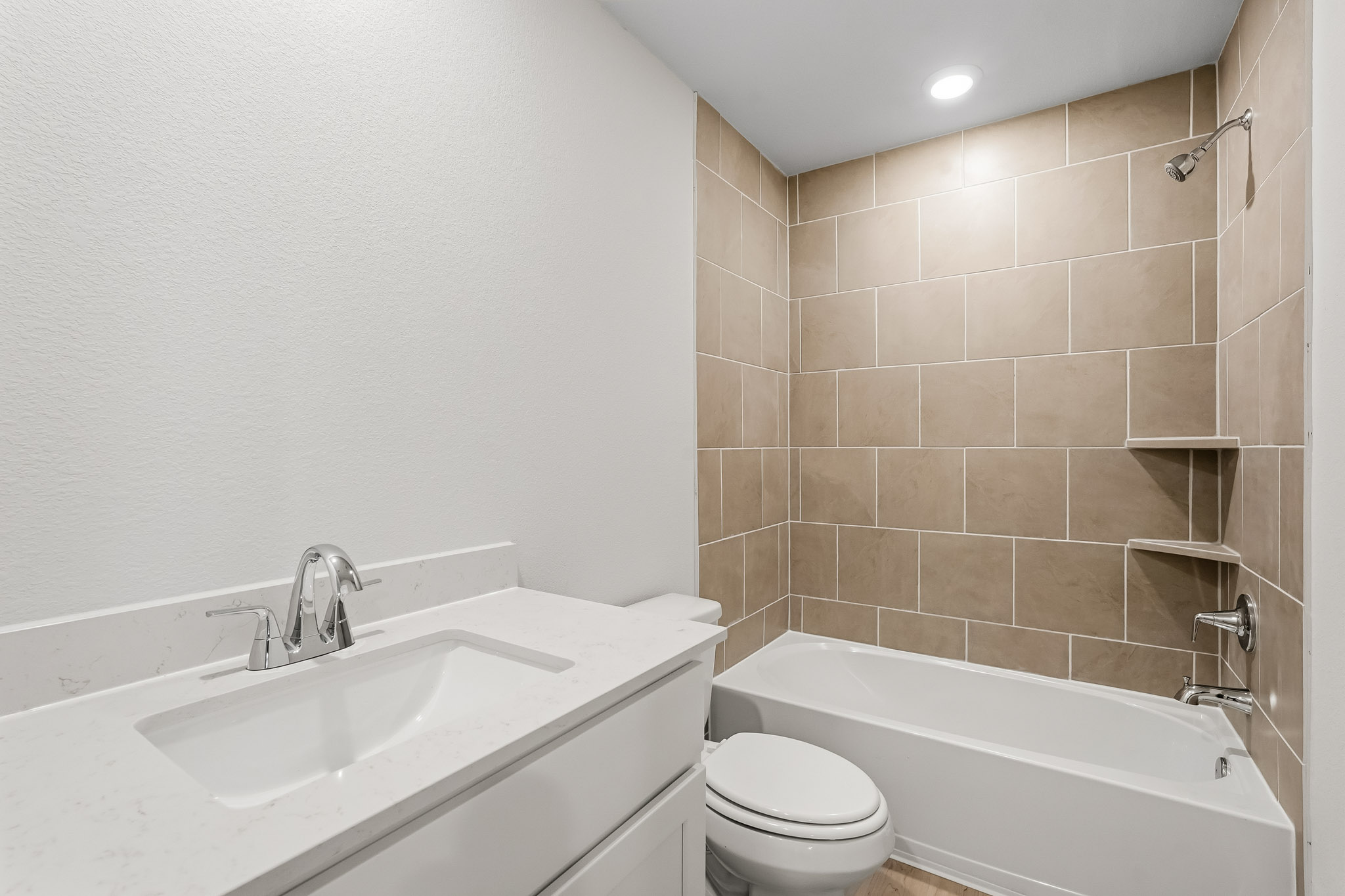 A bathroom with a tub sink and toilet.