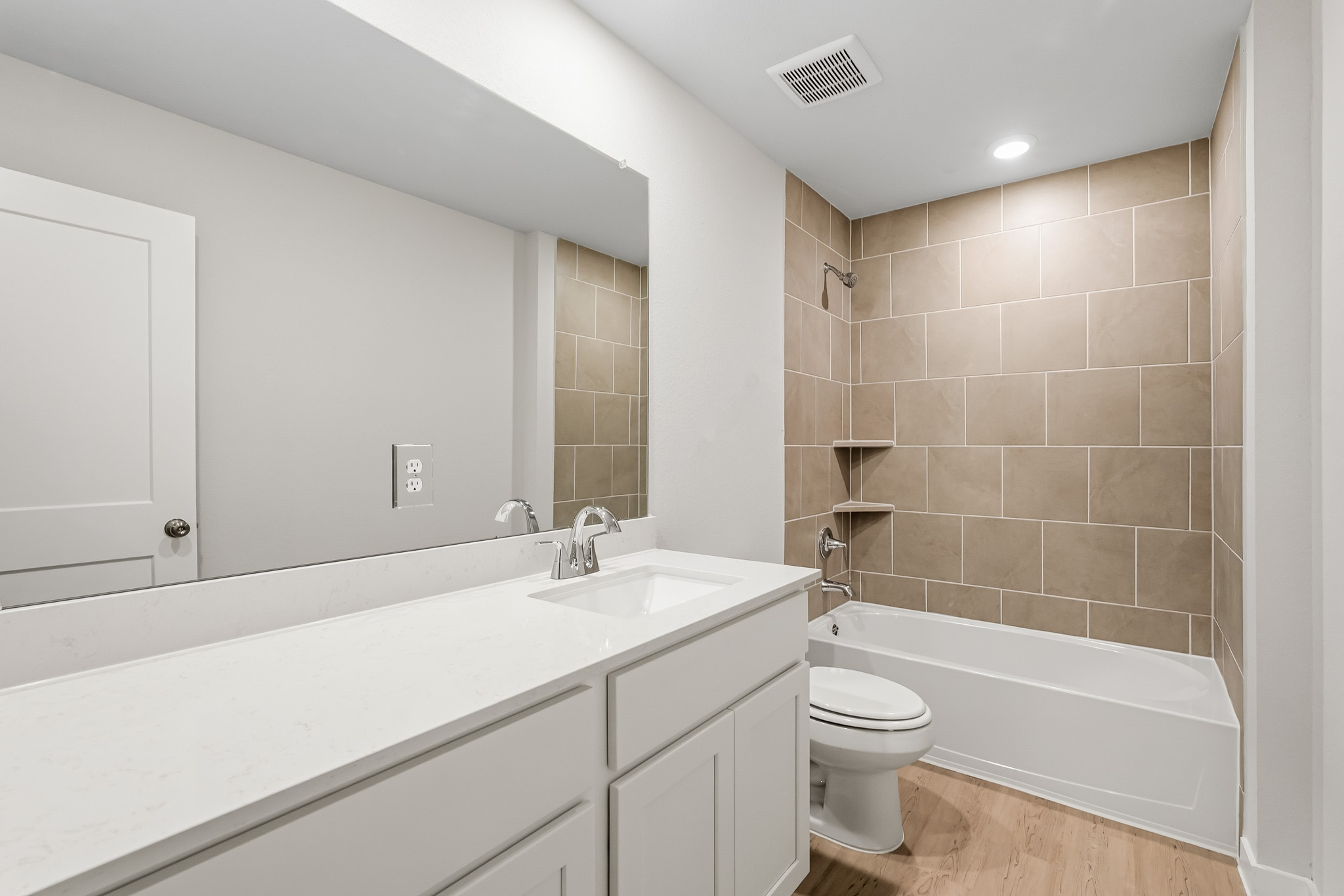 A bathroom with a tub sink and toilet.