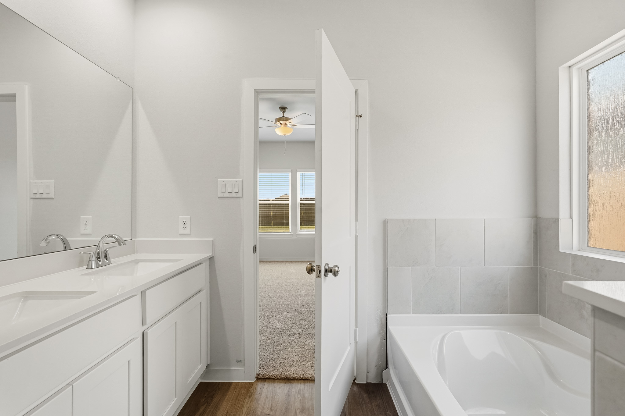 A bathroom with a tub and sink.