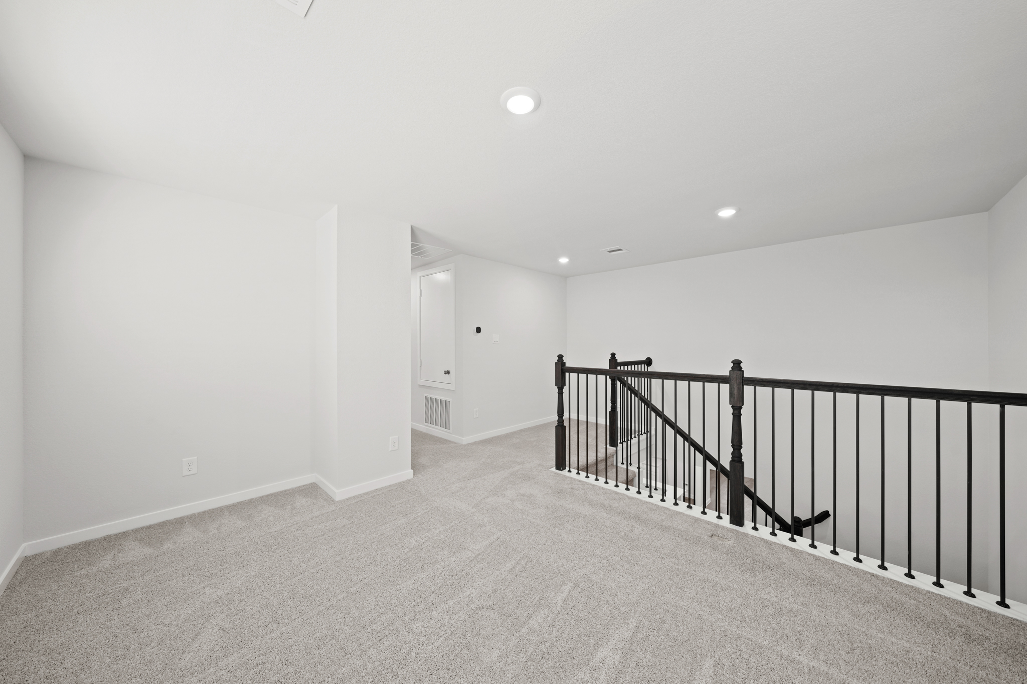 A hallway with a railing.