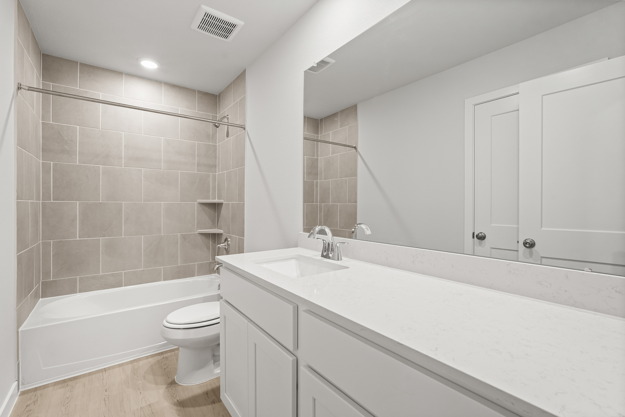 A bathroom with a tub sink and toilet.