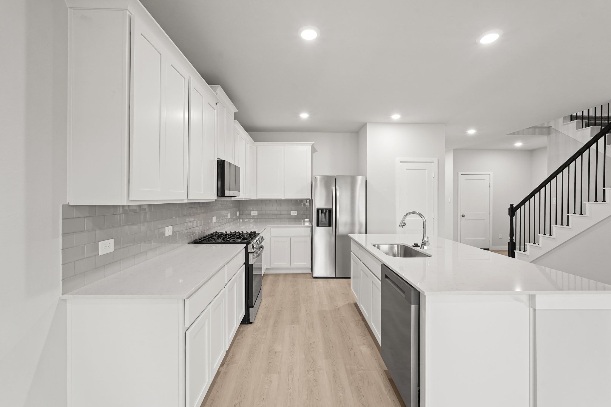A kitchen with white cabinets.