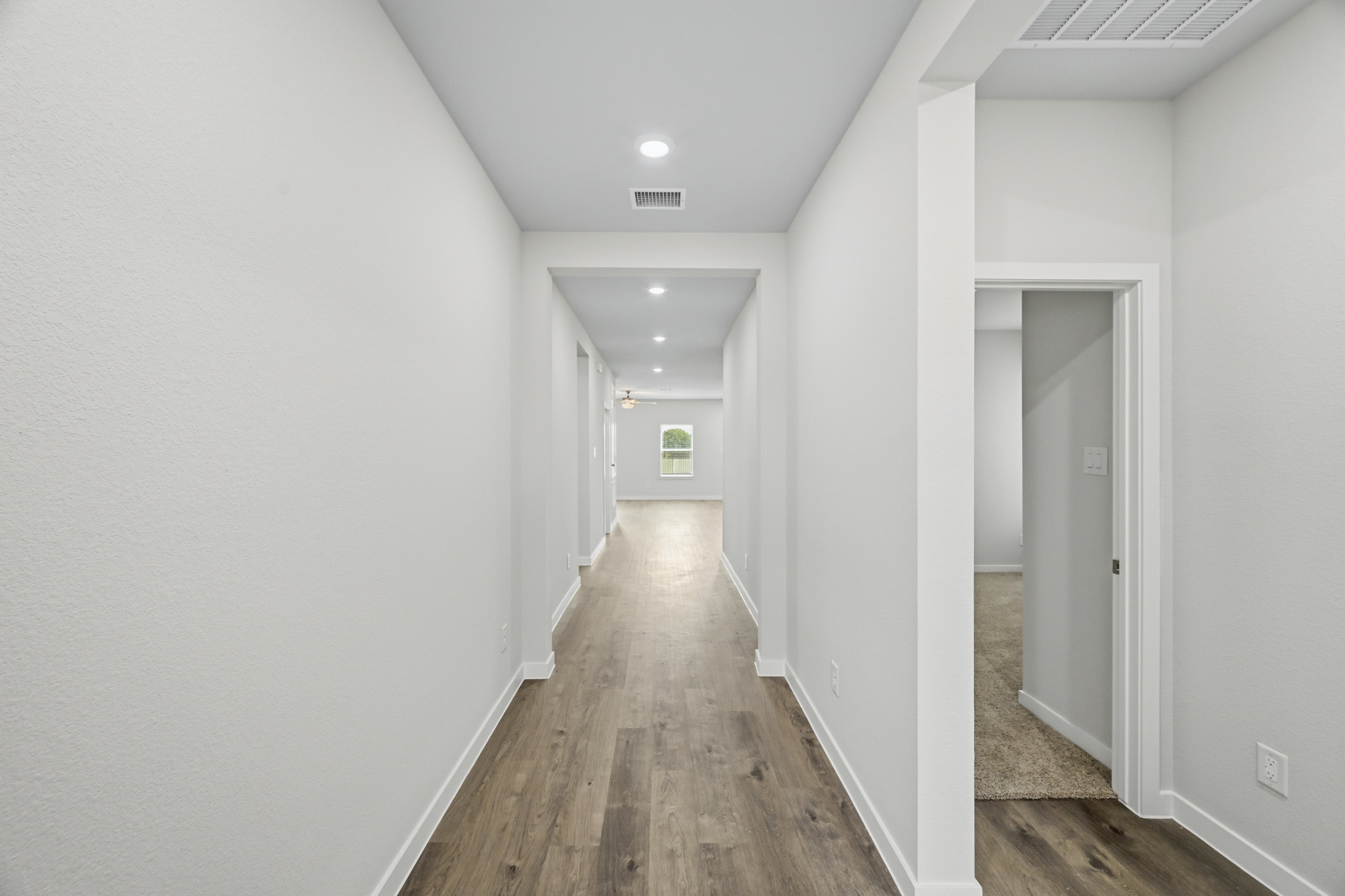 A hallway with white walls.