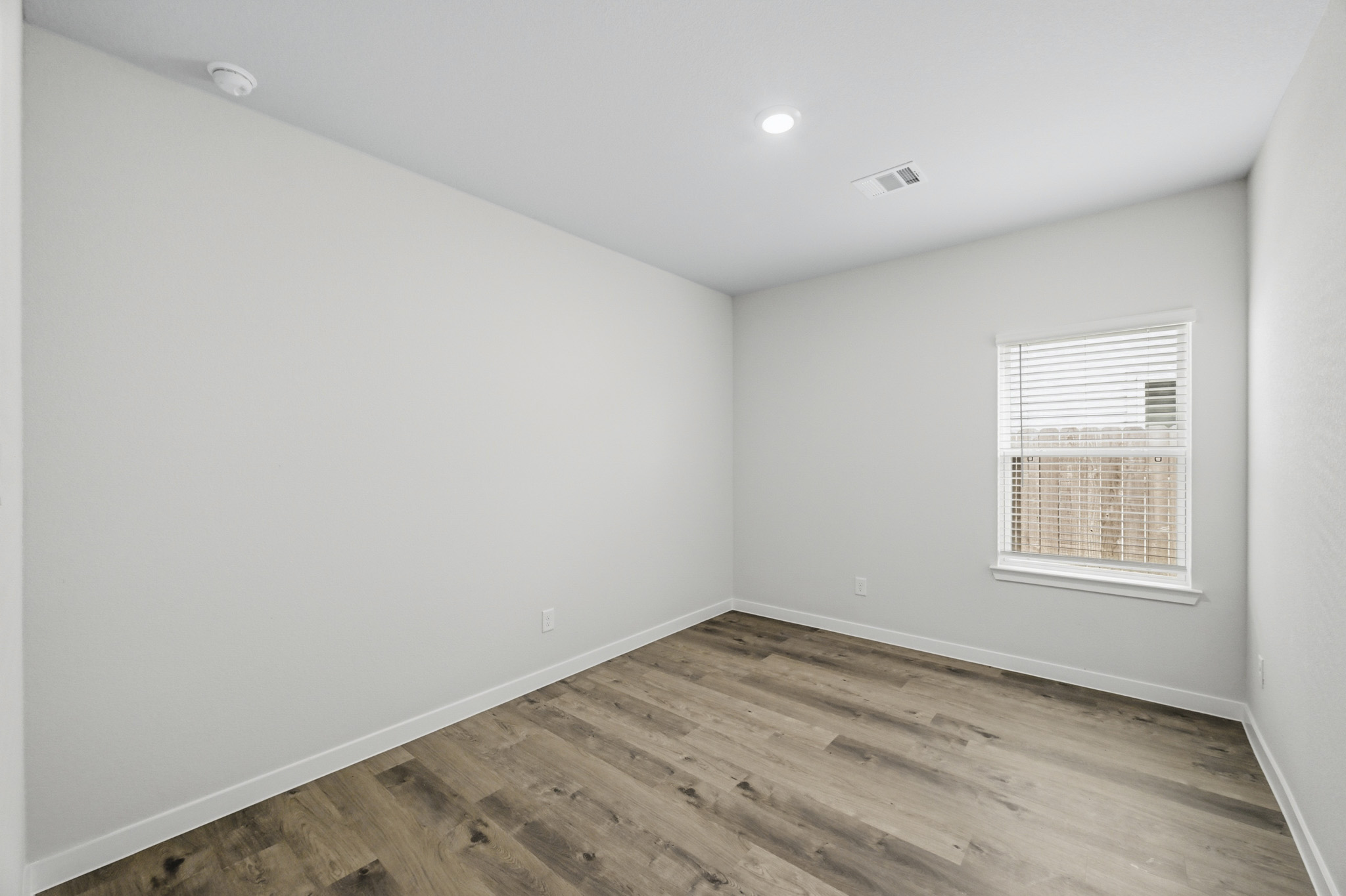 A room with a wood floor and a wood floor.