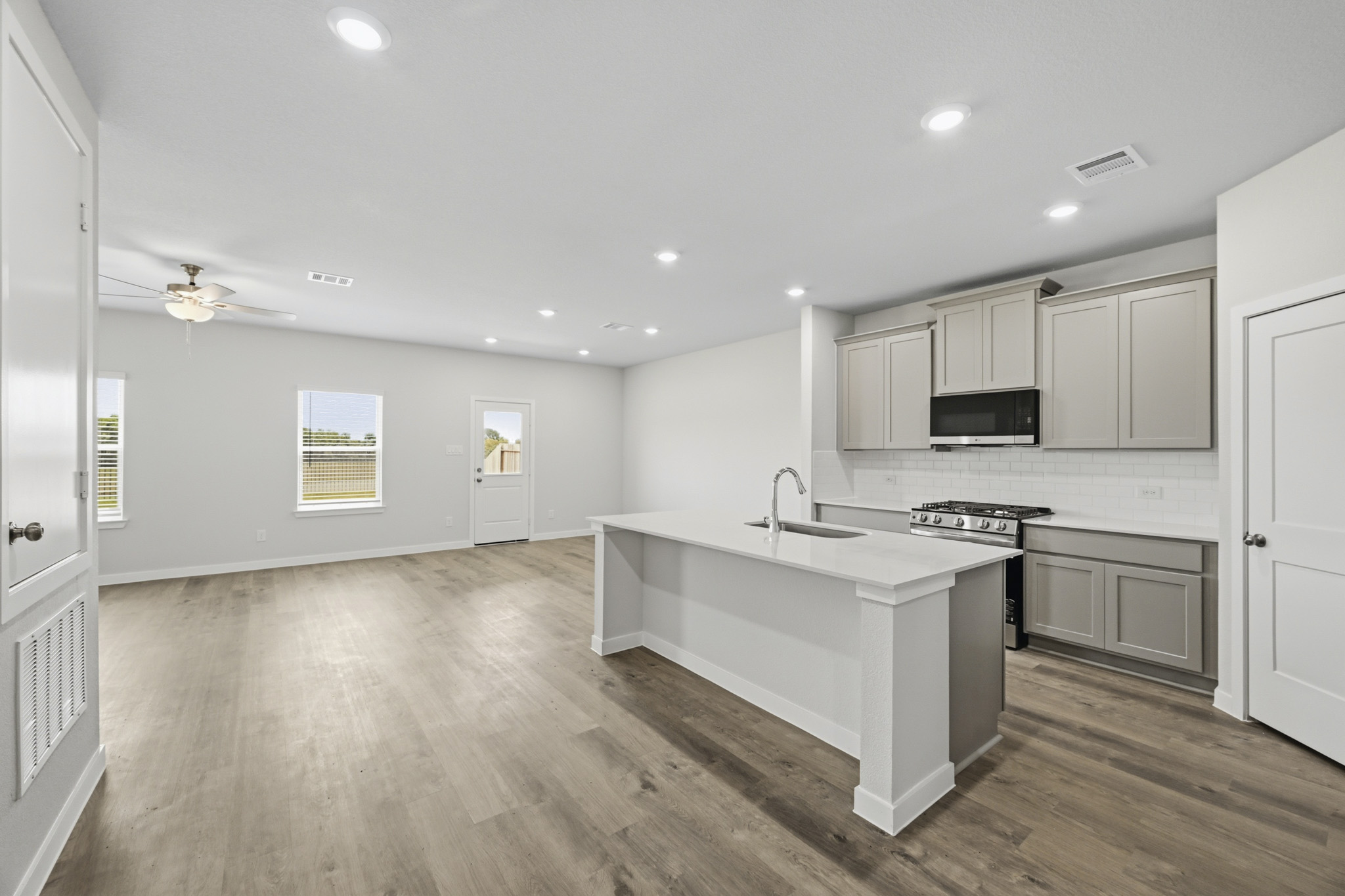 A kitchen with white cabinets.