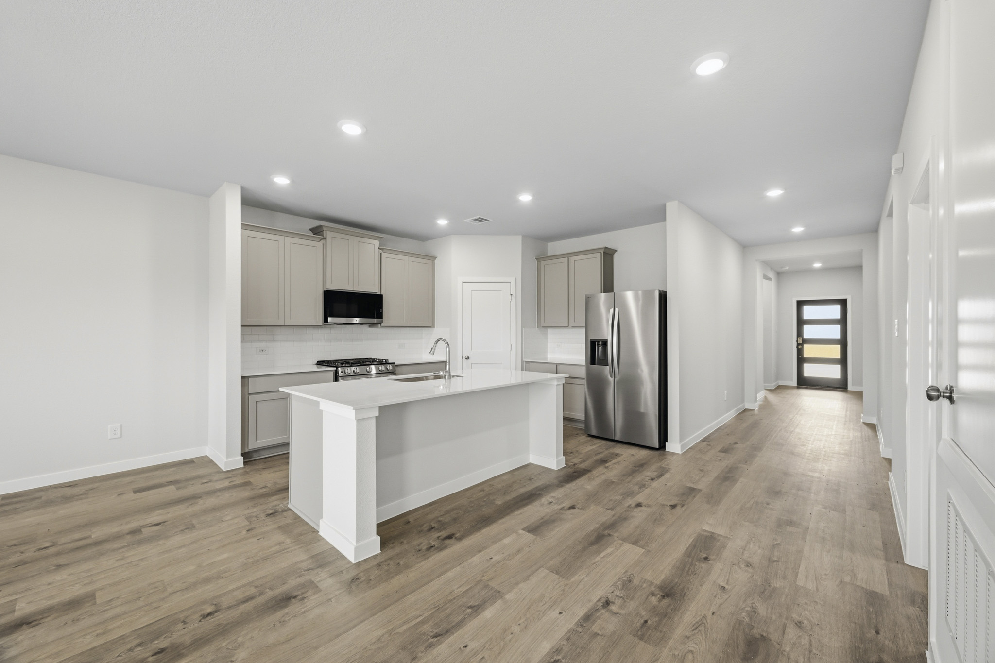 A kitchen with a wood floor.