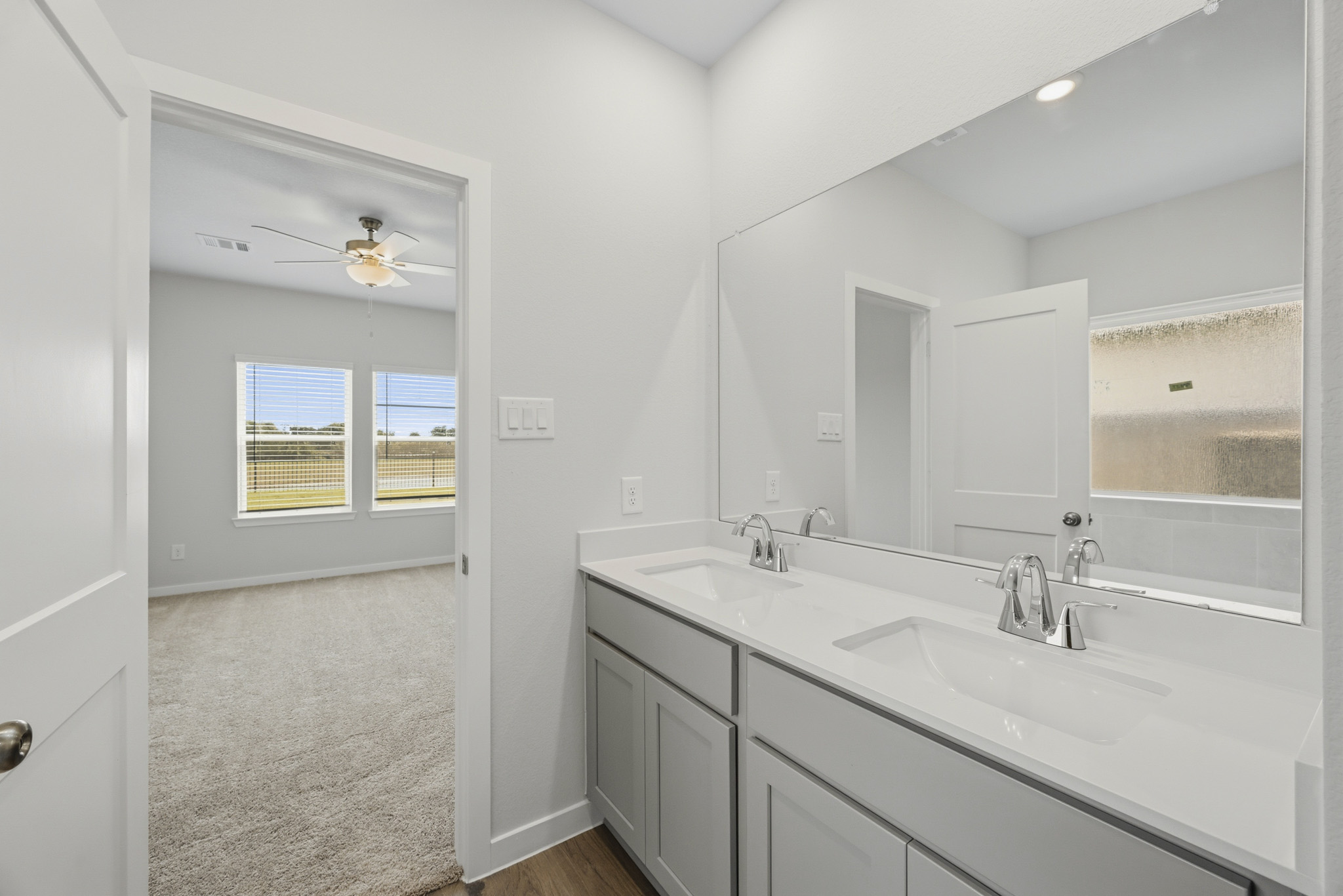 A bathroom with a large mirror.