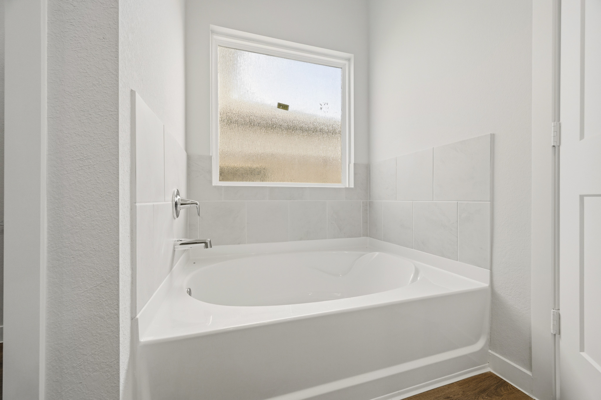 A bathtub in a bathroom.
