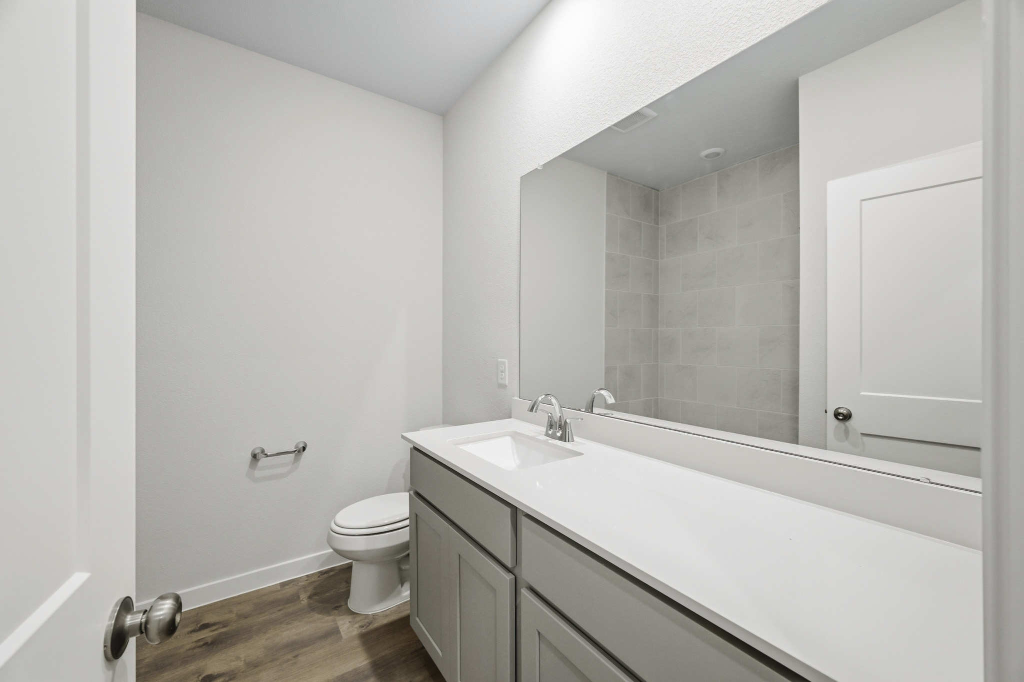 A bathroom with a tub sink and toilet.