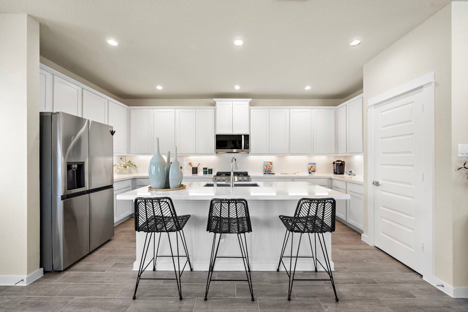A kitchen with white cabinets.