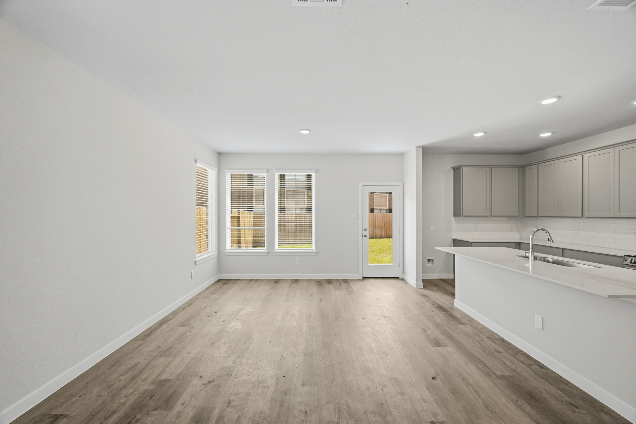 A kitchen with white cabinets.