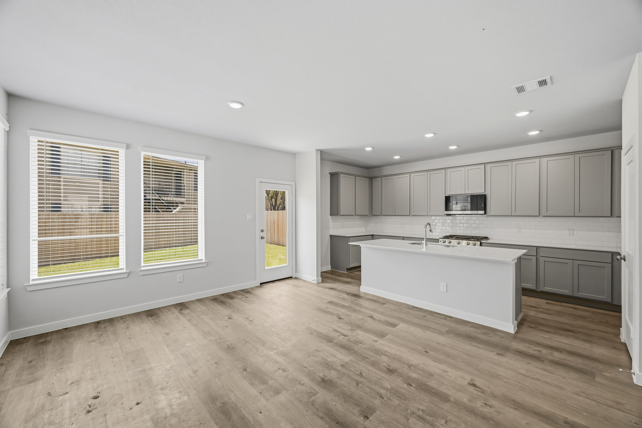 A kitchen with white cabinets.