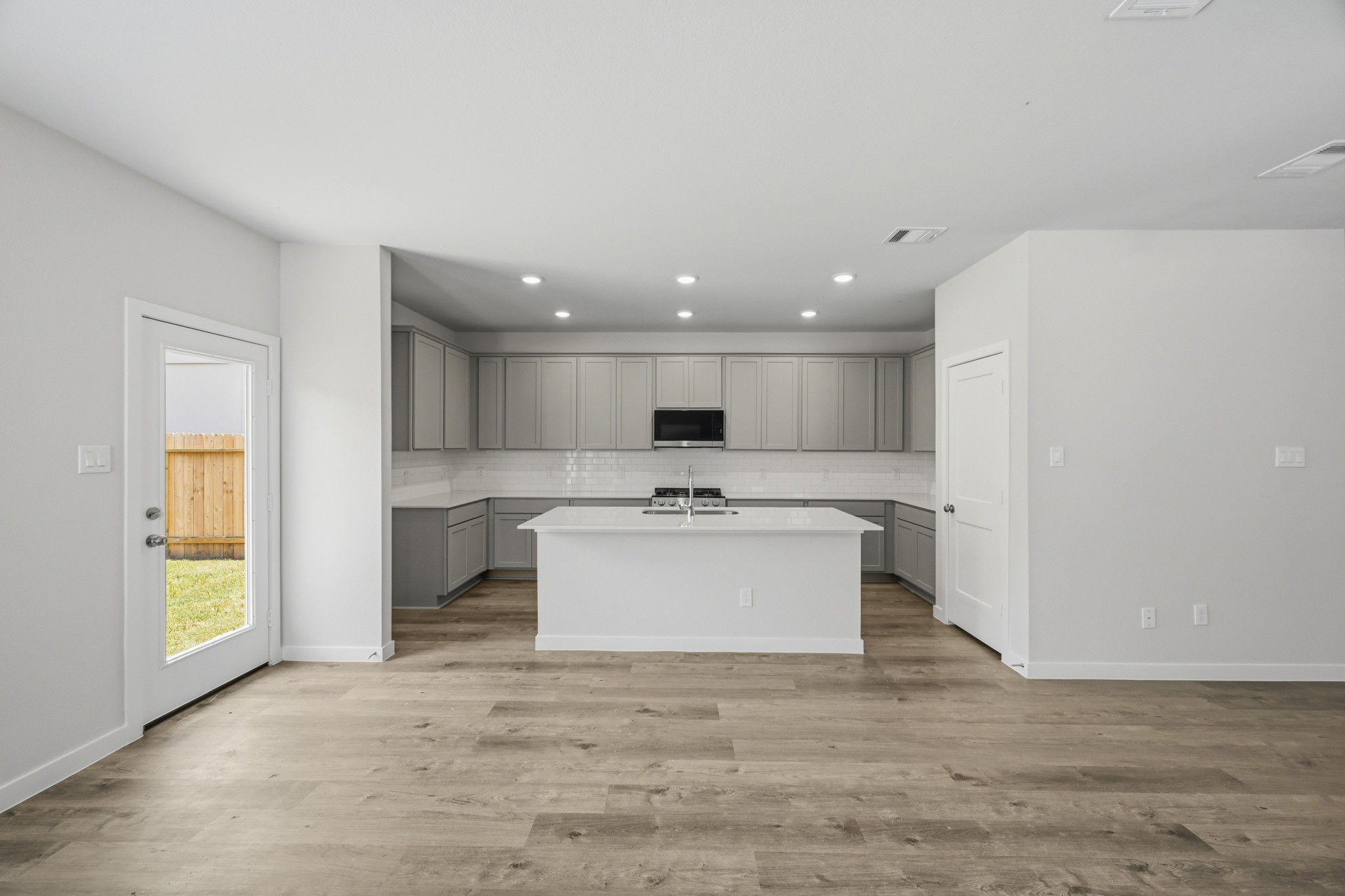 A kitchen with white walls.