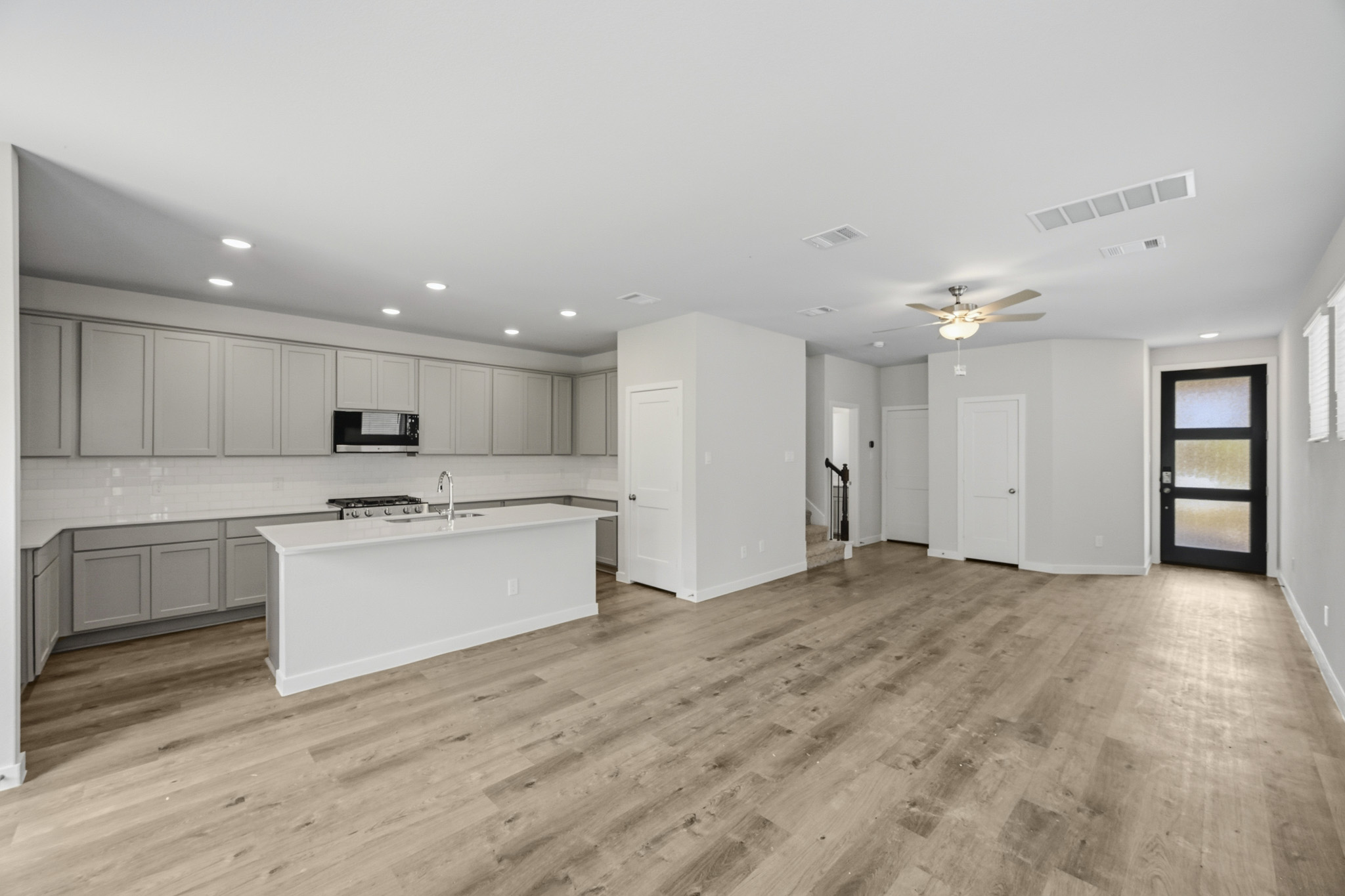 A large kitchen with white cabinets.