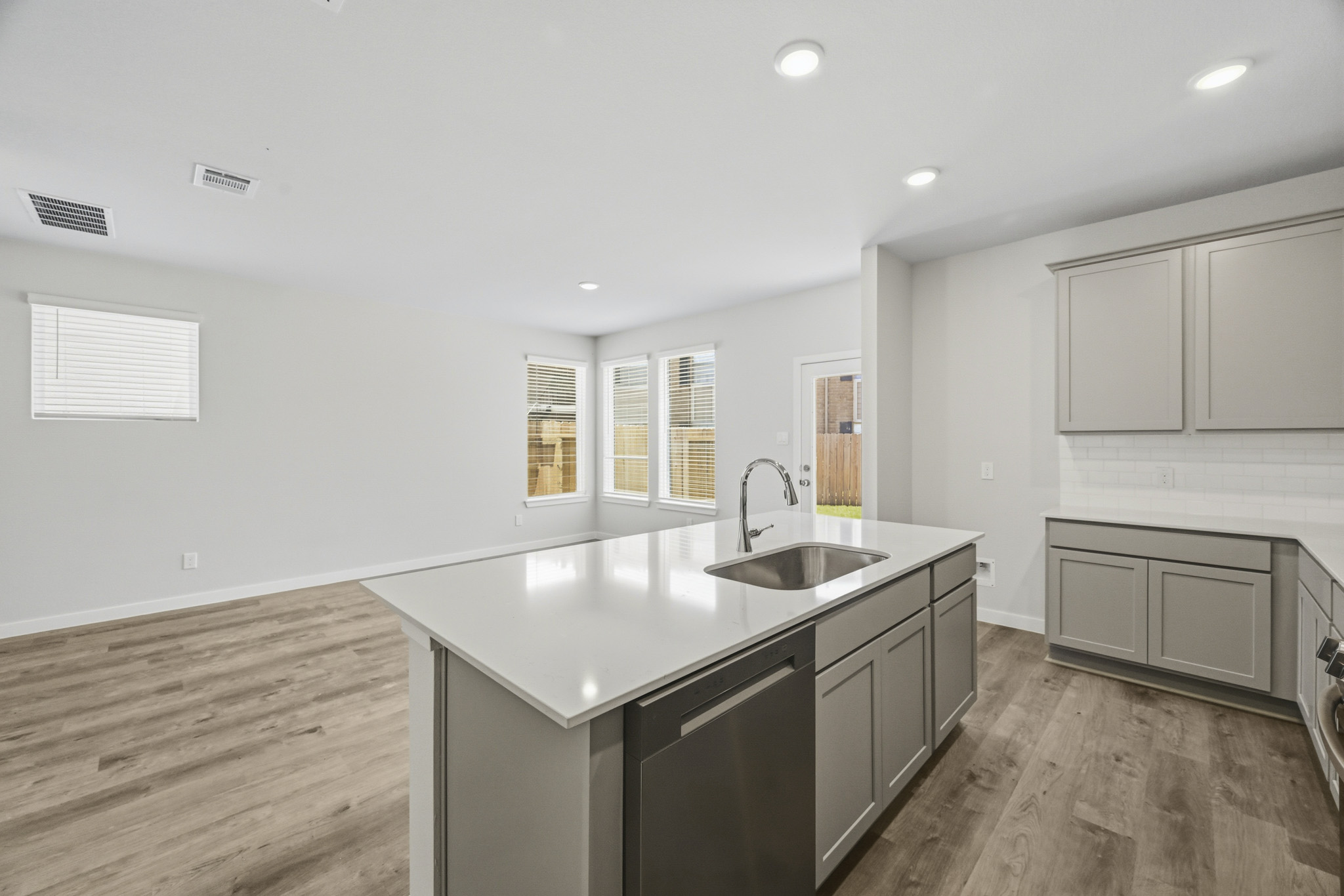 A kitchen with white cabinets.