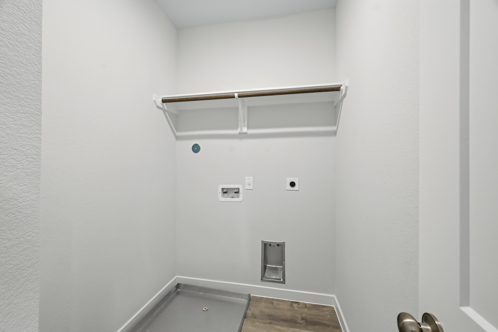A bathroom with a sink and a shower unit.