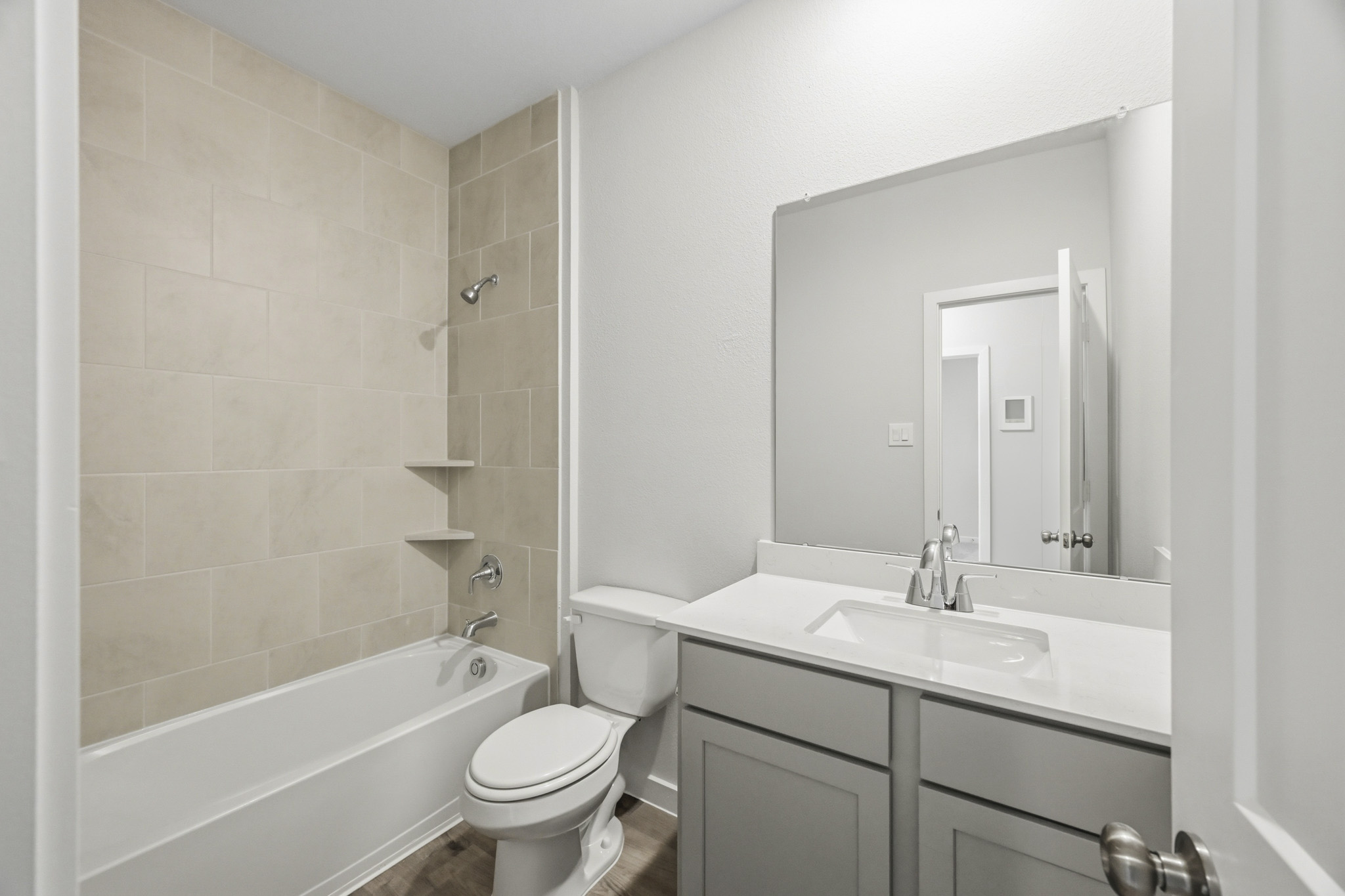 A bathroom with a tub sink and toilet.