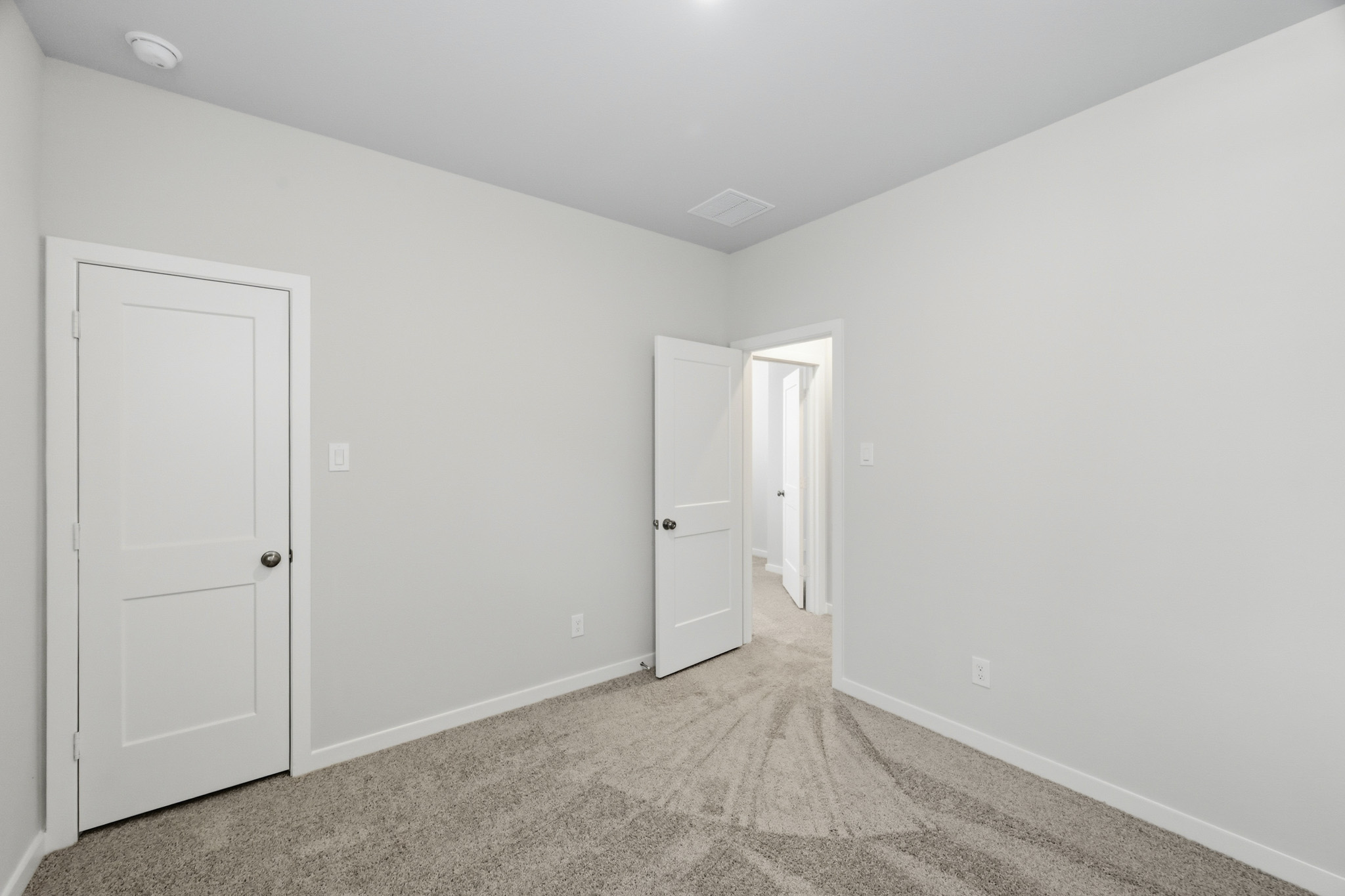 A hallway with white doors.