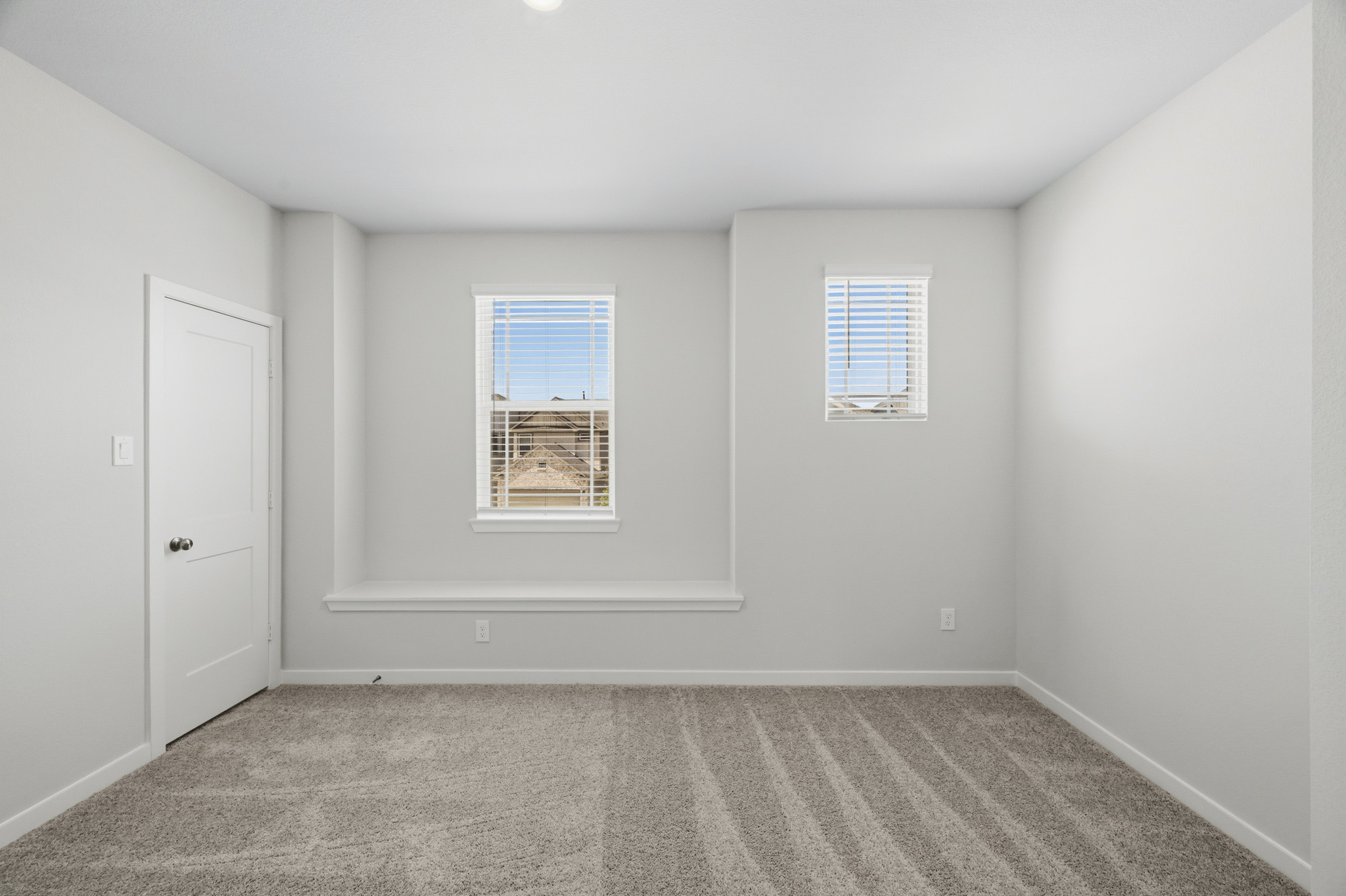 A room with white walls and a door.