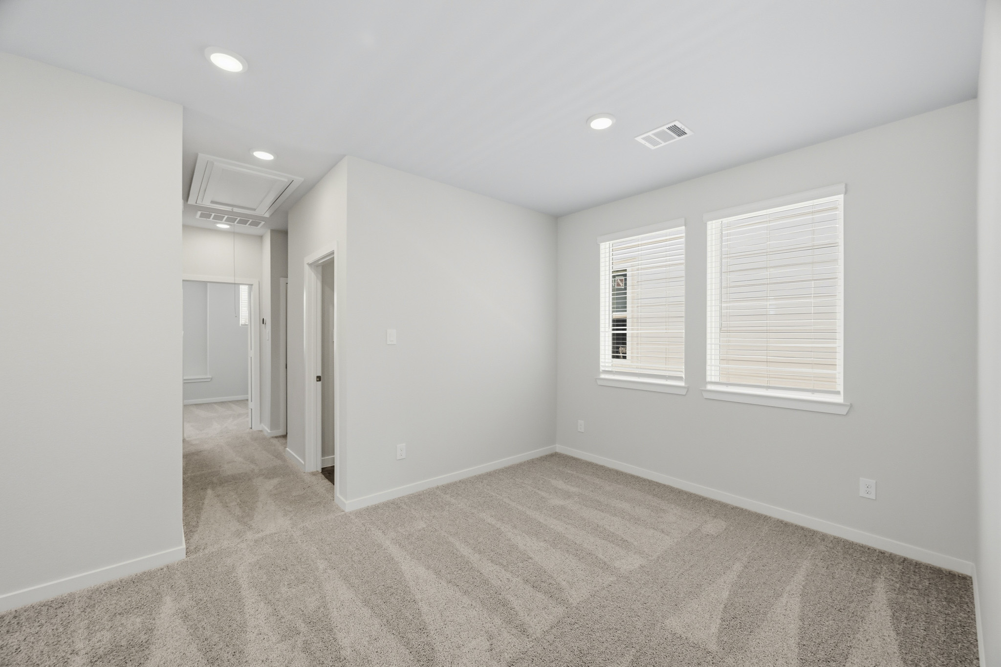 A hallway with white walls.