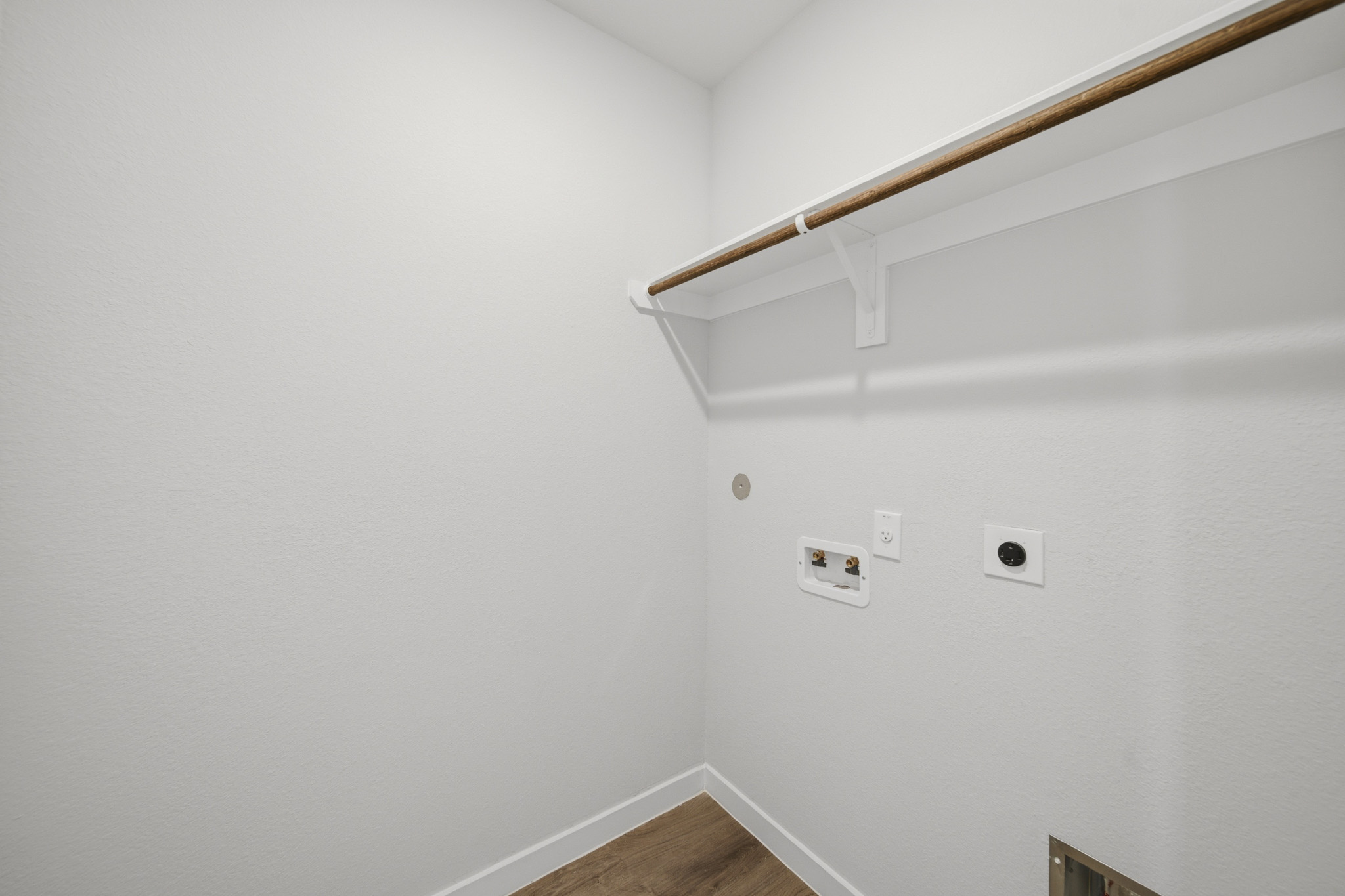 A white wall with a light fixture.