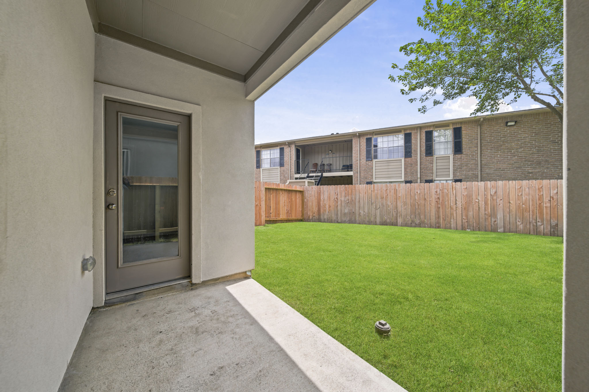 A house with a fence and grass.