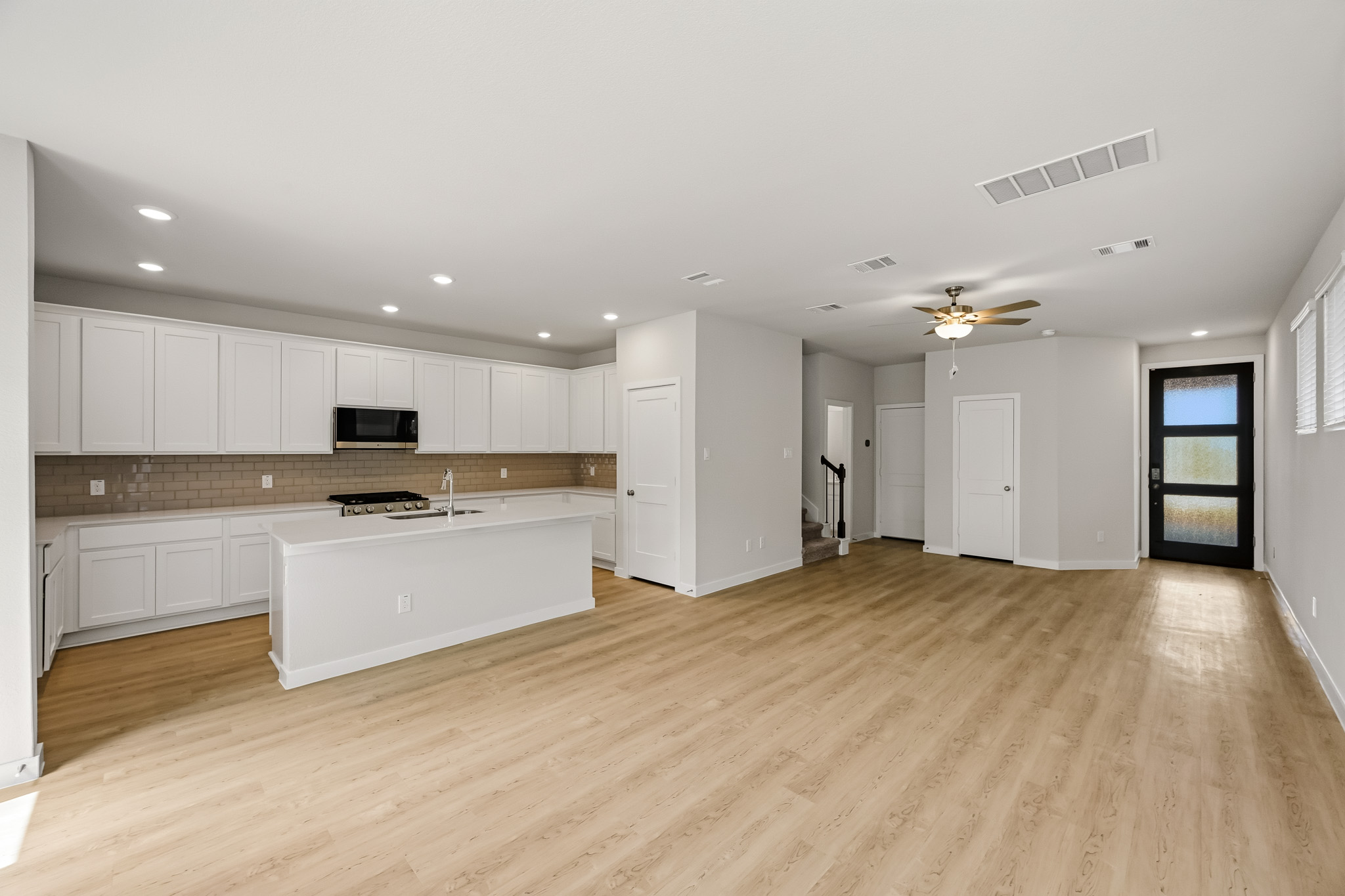 A large kitchen with white cabinets.