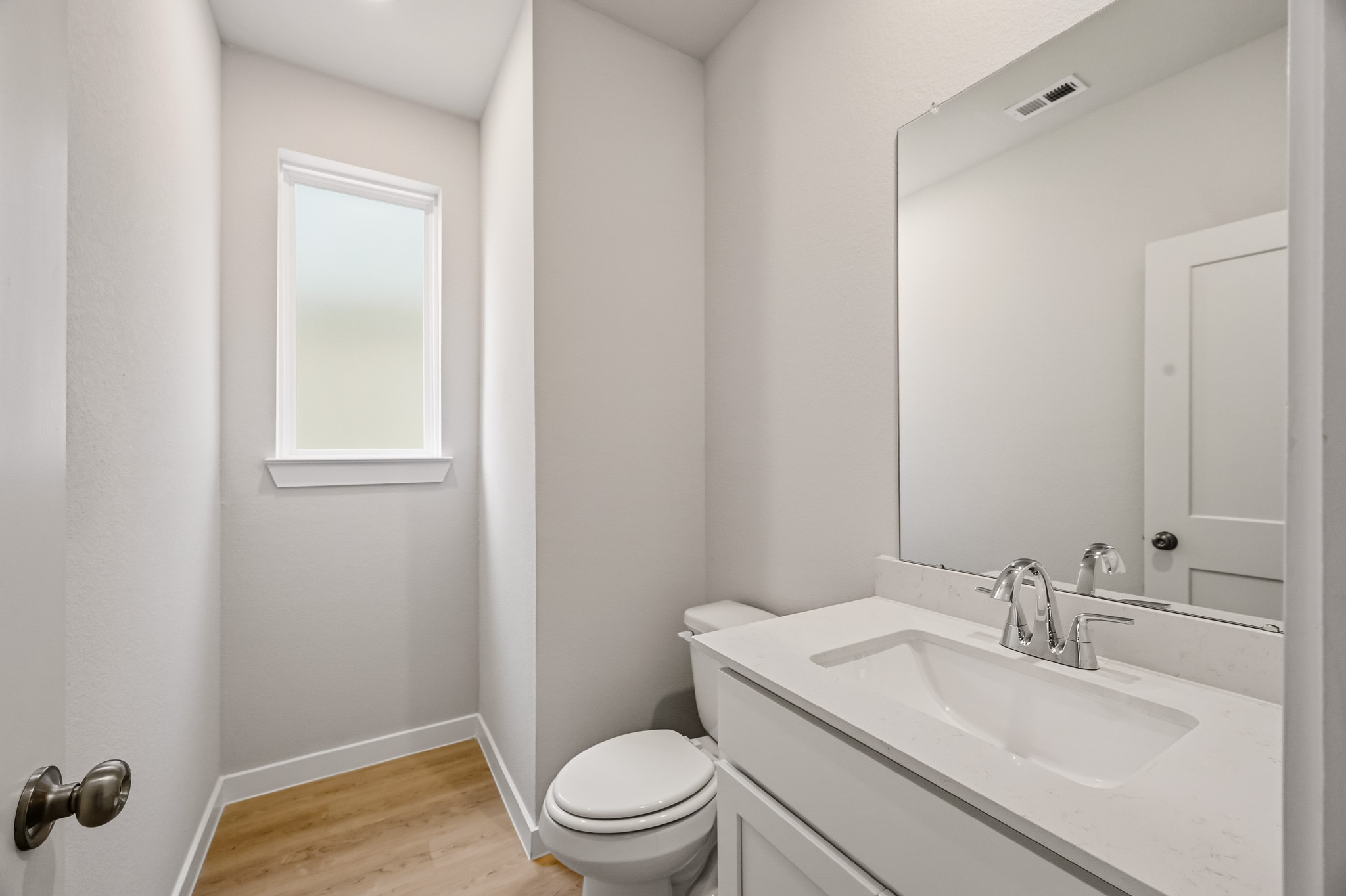 A bathroom with a toilet and sink.