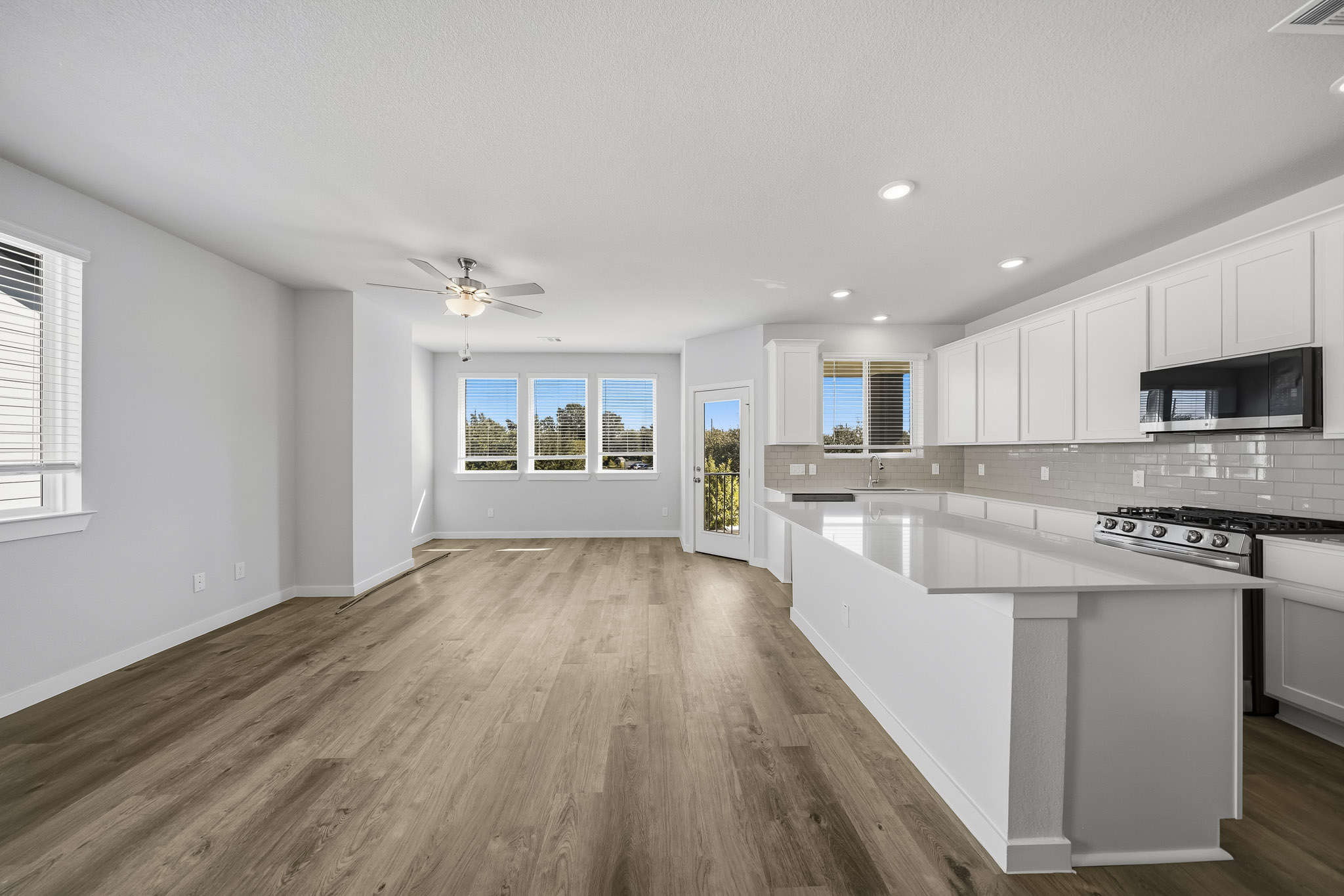 A kitchen with white cabinets.