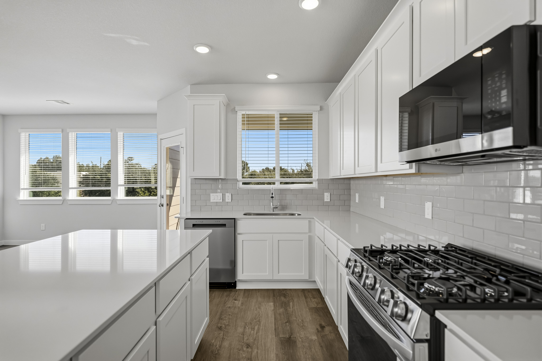 A kitchen with white cabinets.