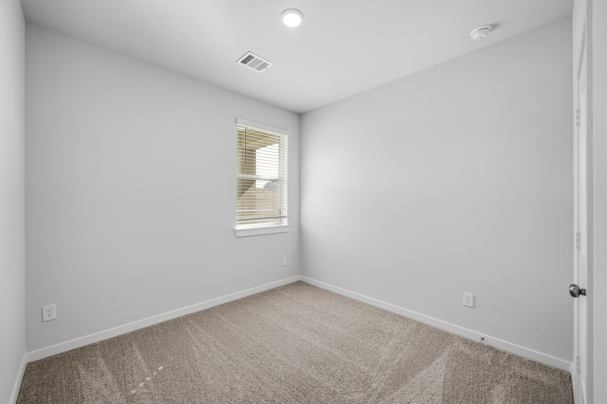 A room with a door and a window.