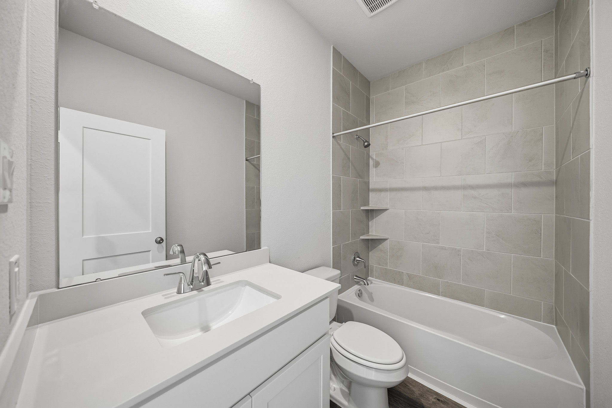 A bathroom with a tub sink and toilet.