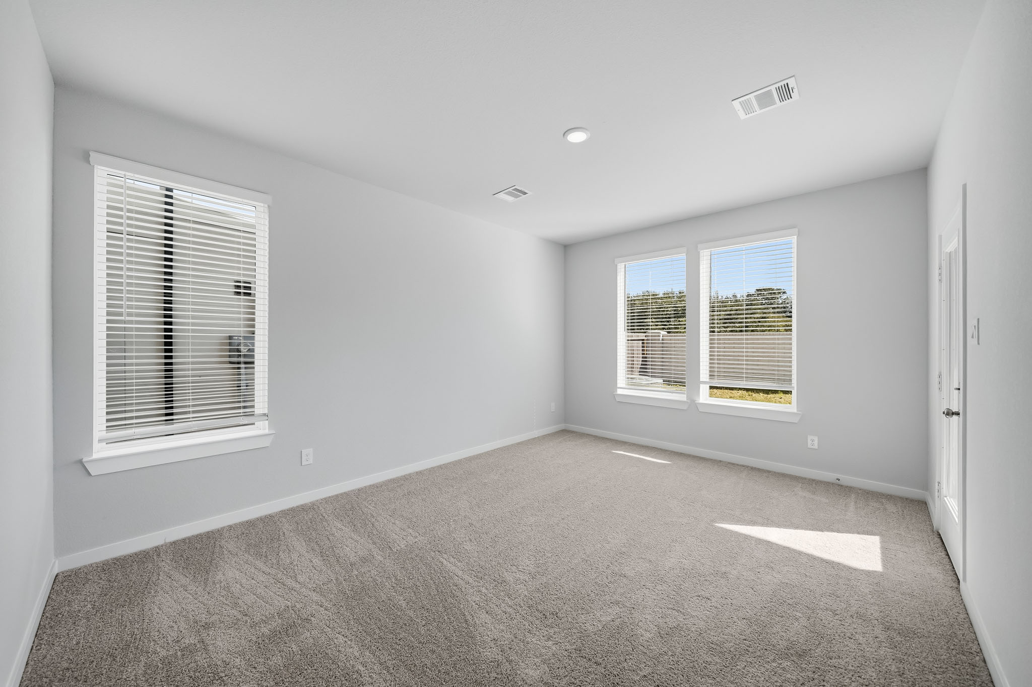 A room with a window and blinds.
