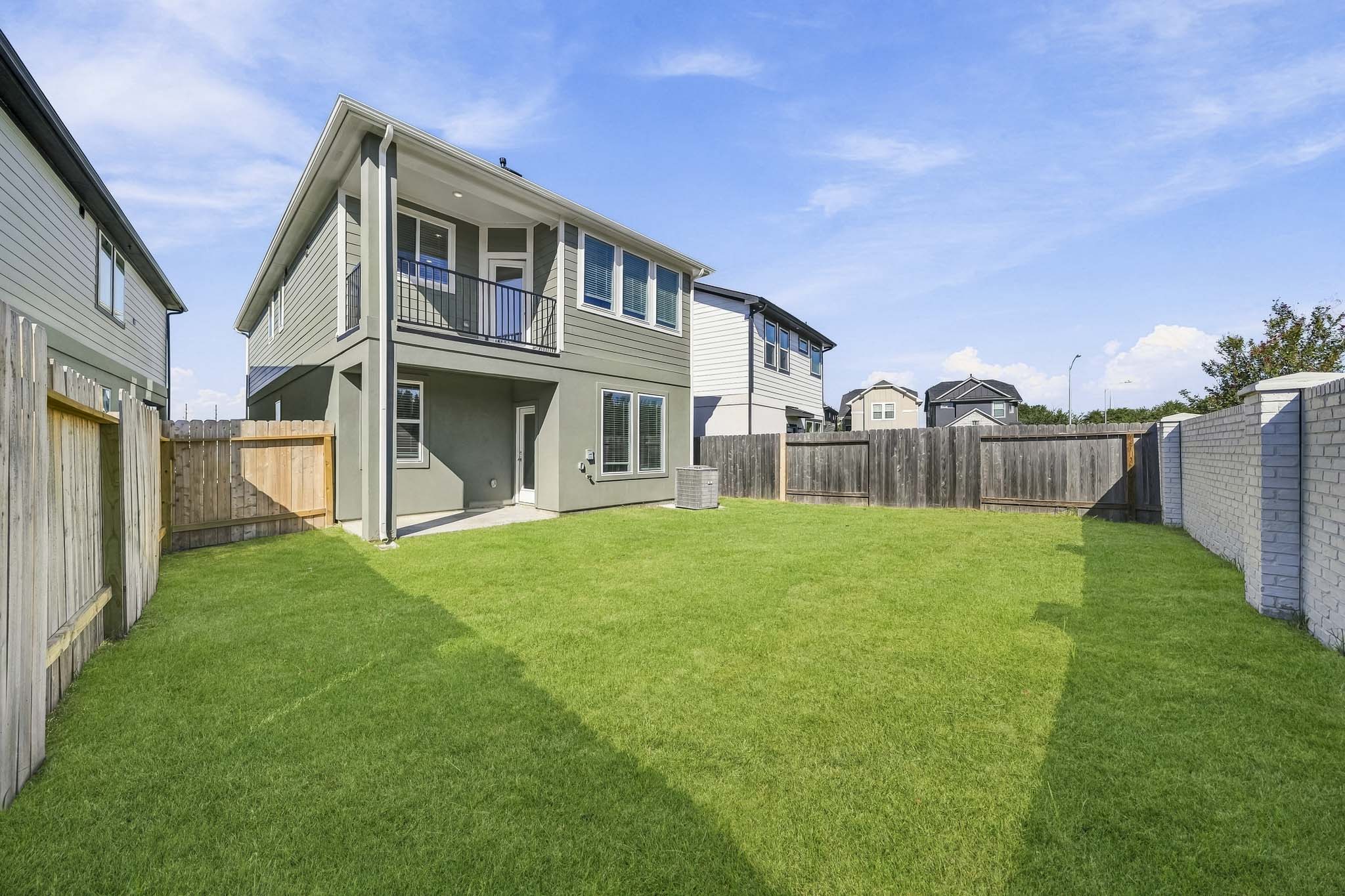 A house with a fence and grass.