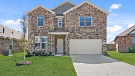 A brick house with a driveway.