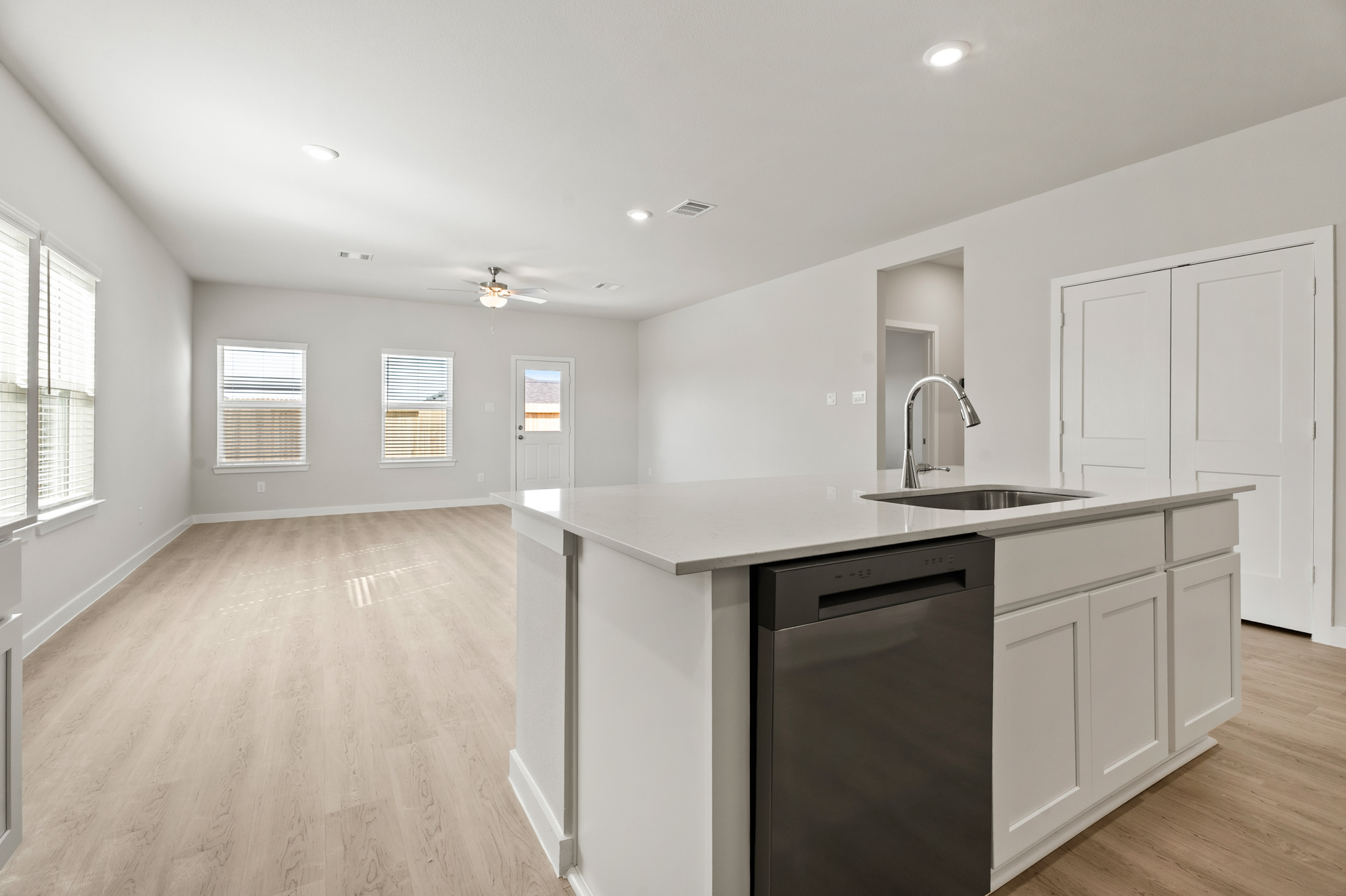 A kitchen with white cabinets.