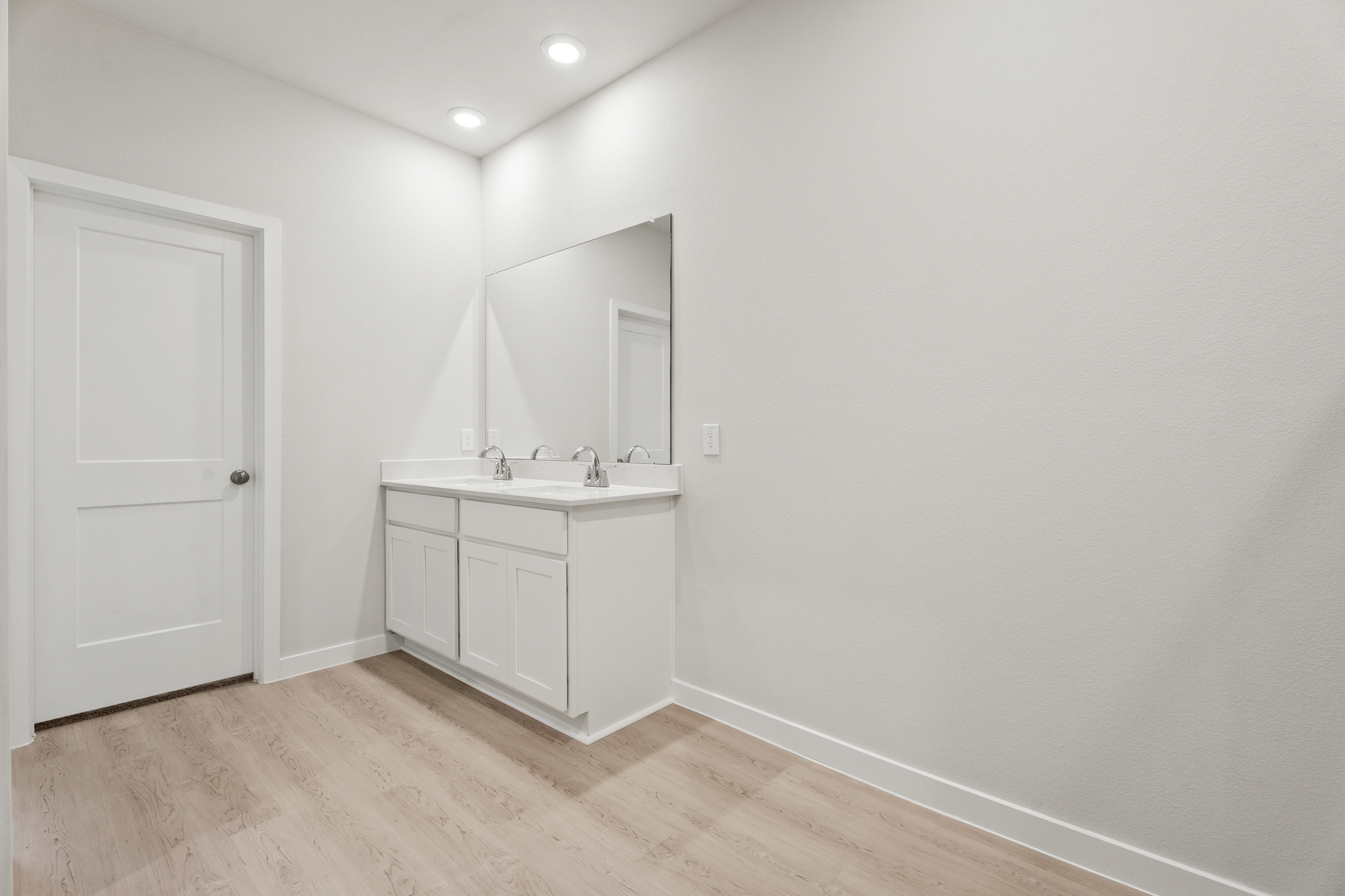 A bathroom with white walls.