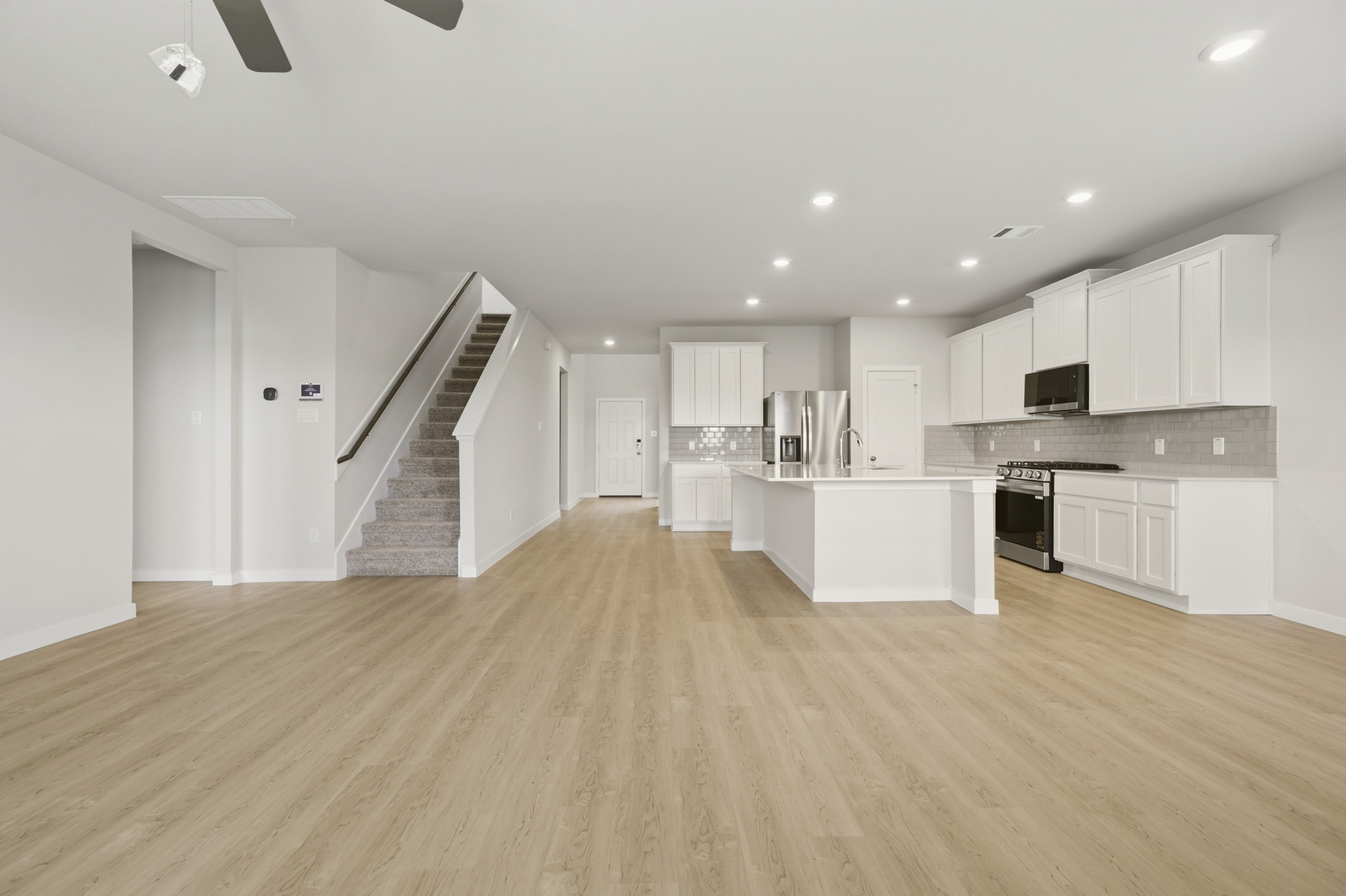 A large kitchen with white cabinets.
