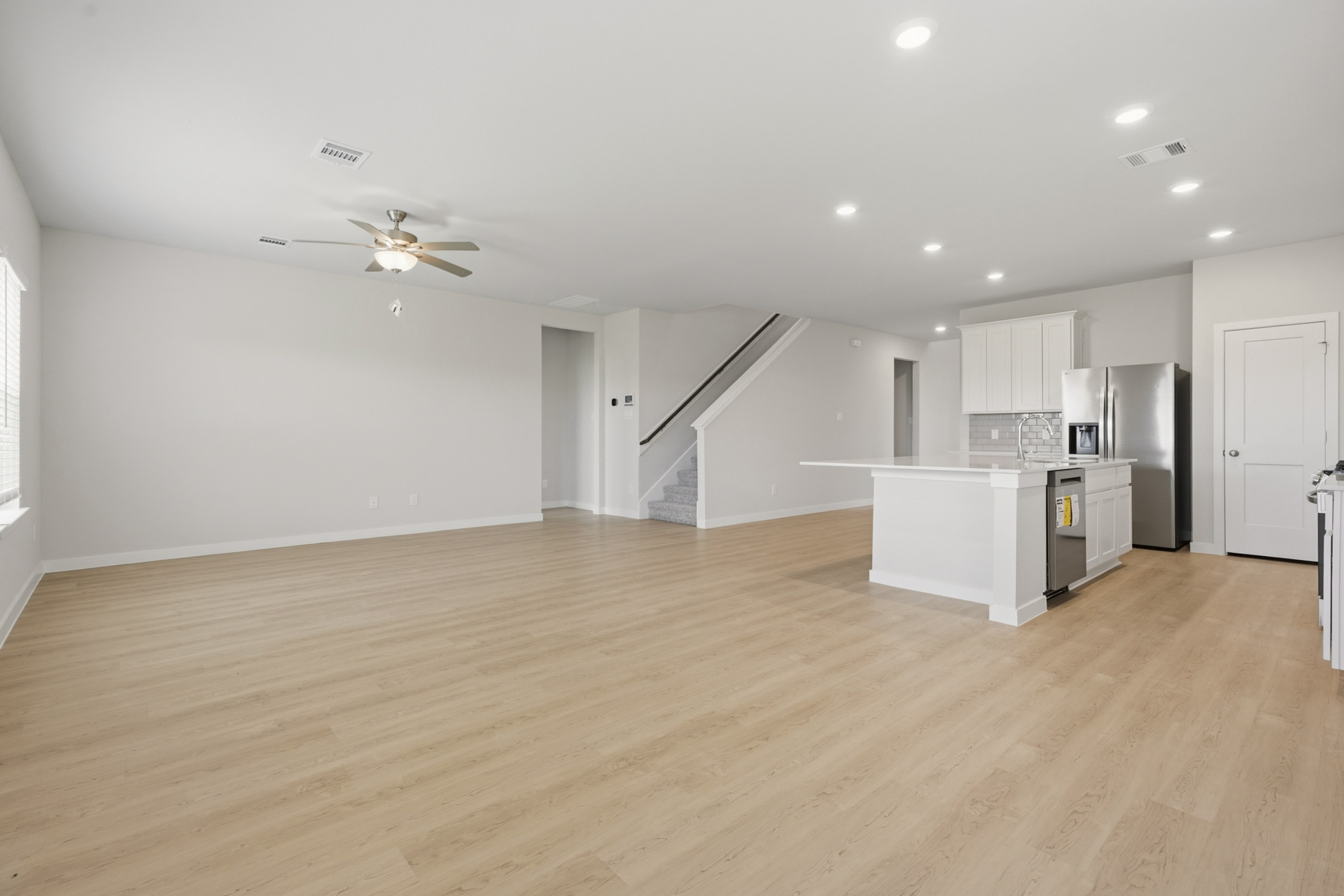 A large kitchen with white cabinets.