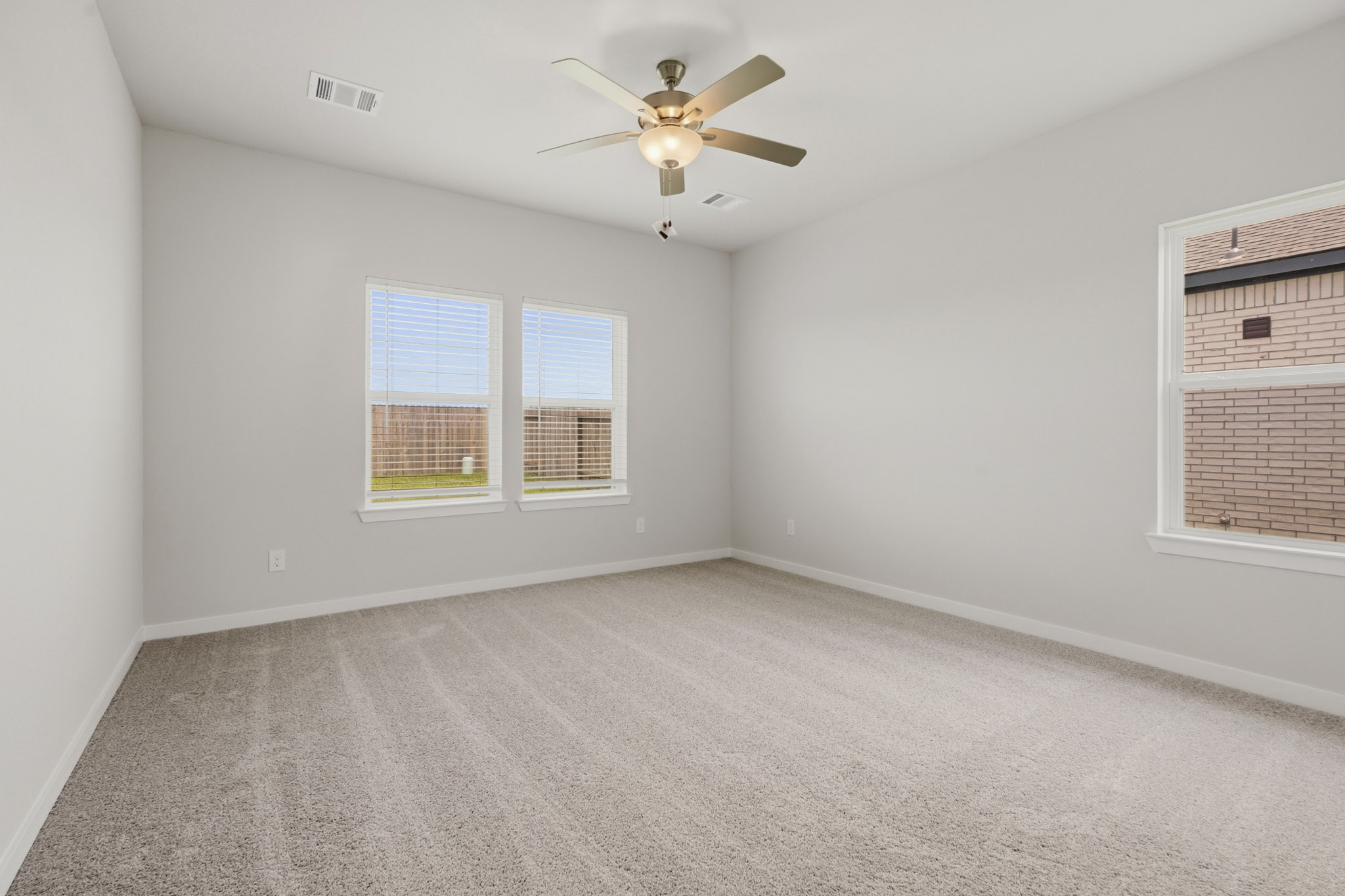 A room with a ceiling fan and a window.