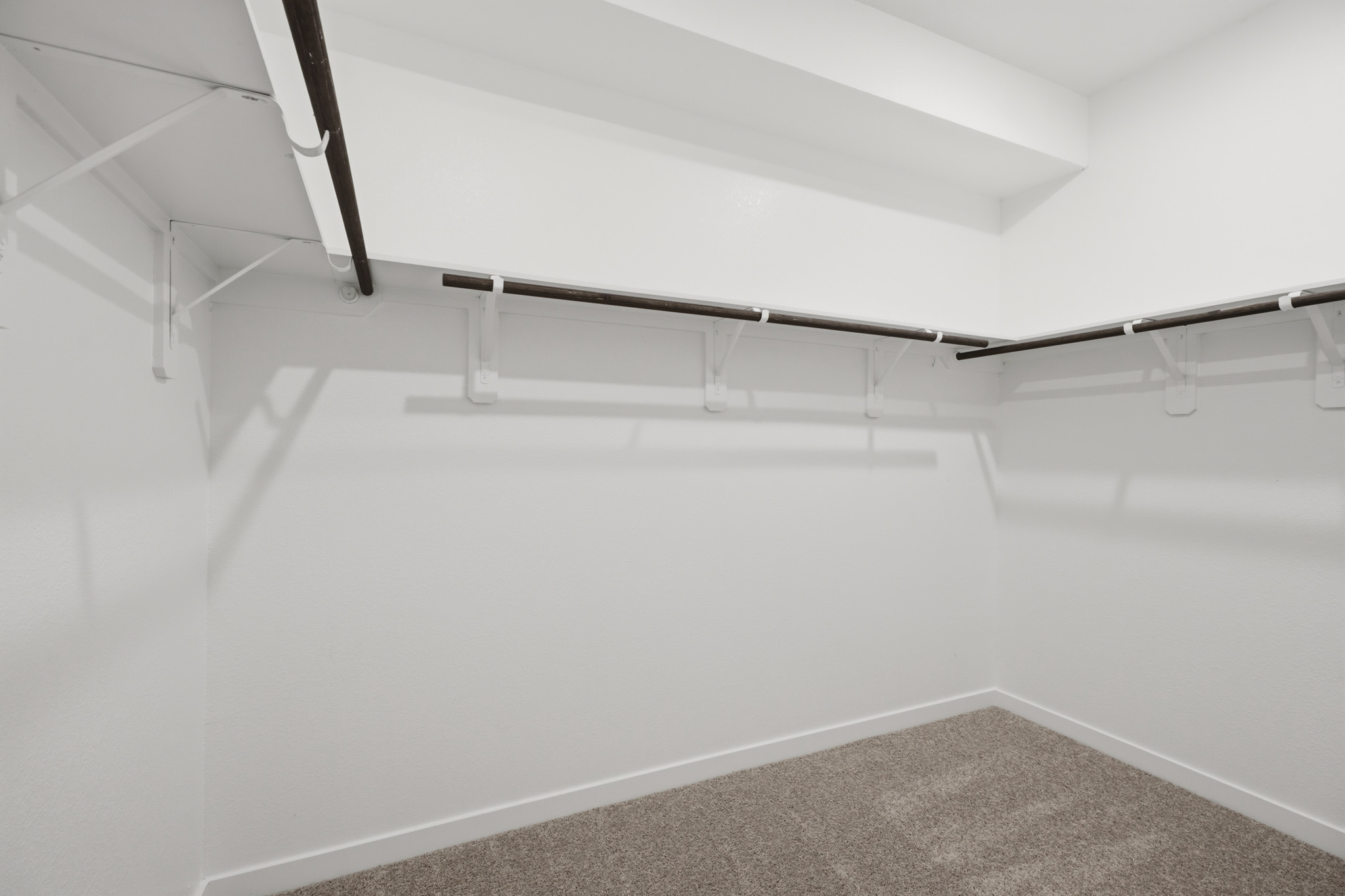 A white staircase with a carpet.