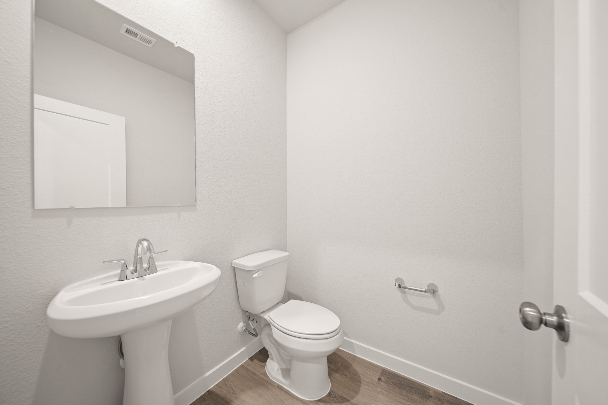 A bathroom with a toilet and sink.