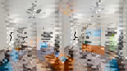 A living room with a ceiling fan.