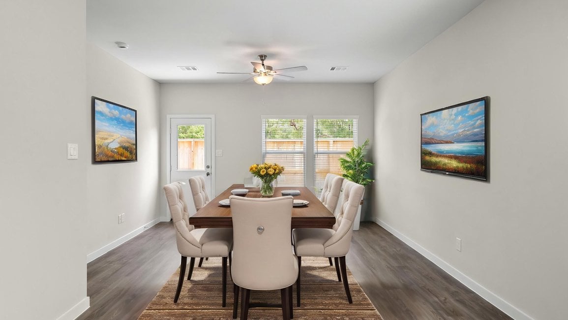 A dining room table with chairs.