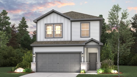 A house with a garage and trees around it.