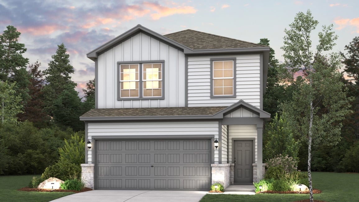 A house with a garage and trees around it.